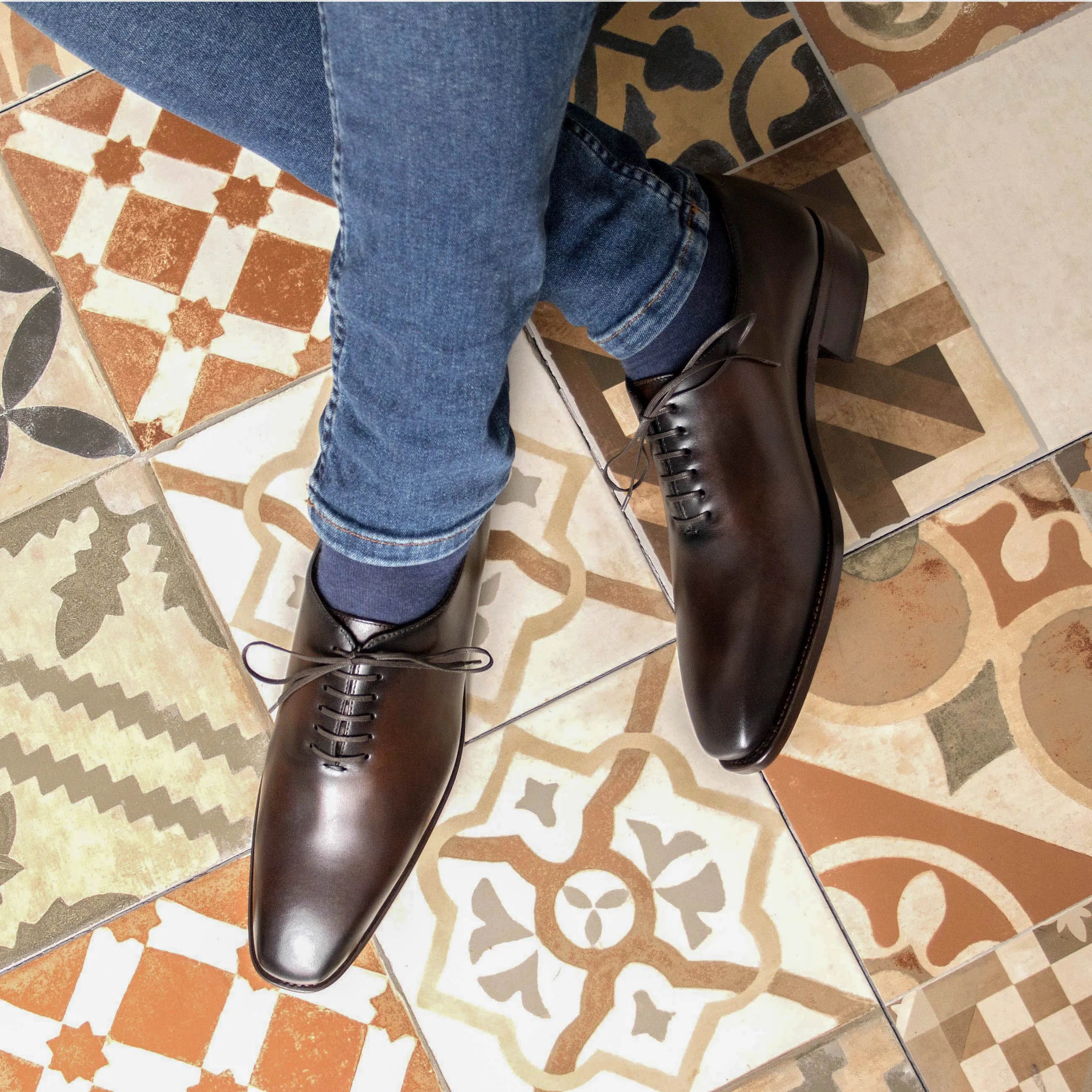 Brown leather Elio Wholecut shoes showcasing elegant craftsmanship and style