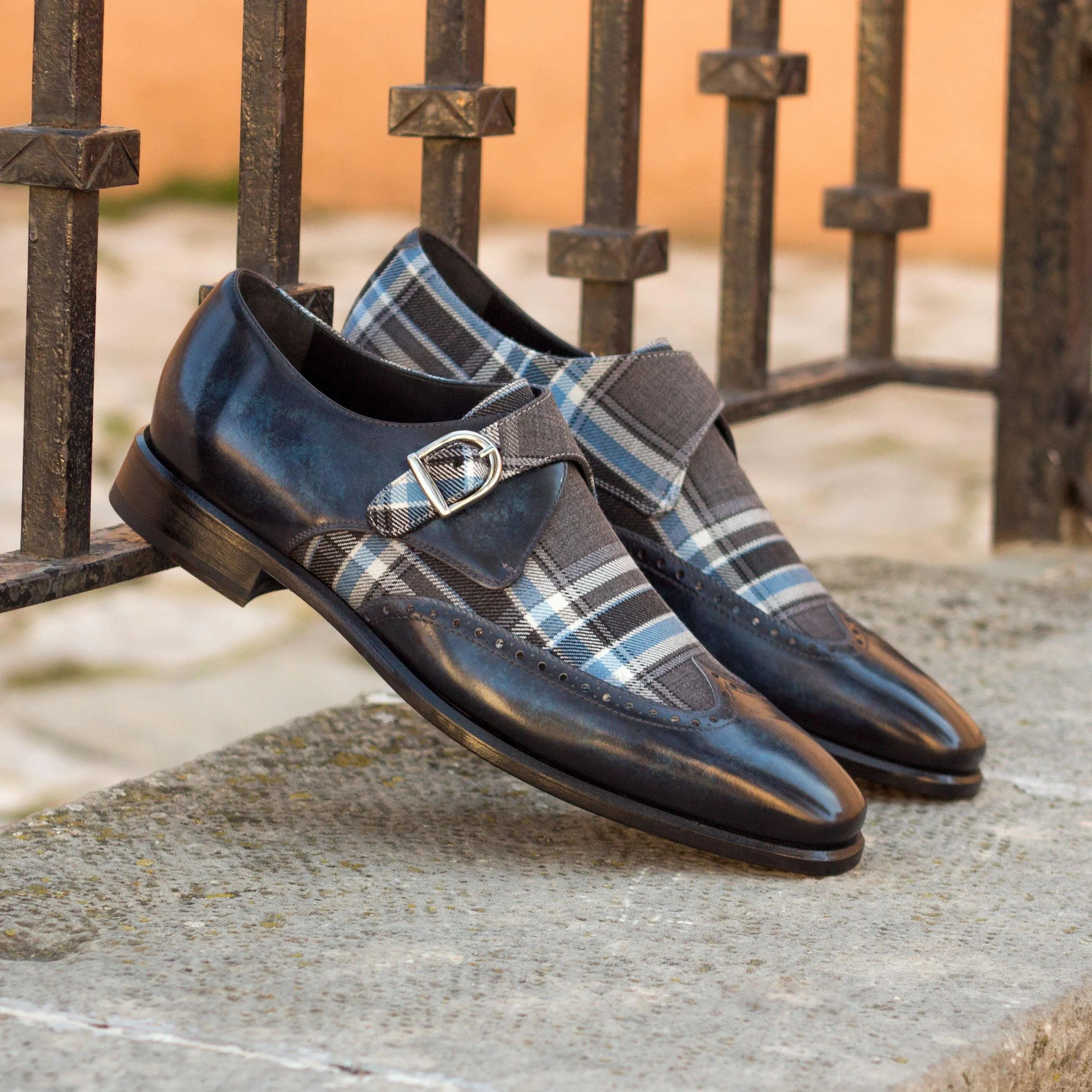 Pair of Empire Single Monk Patina shoes featuring black and plaid design