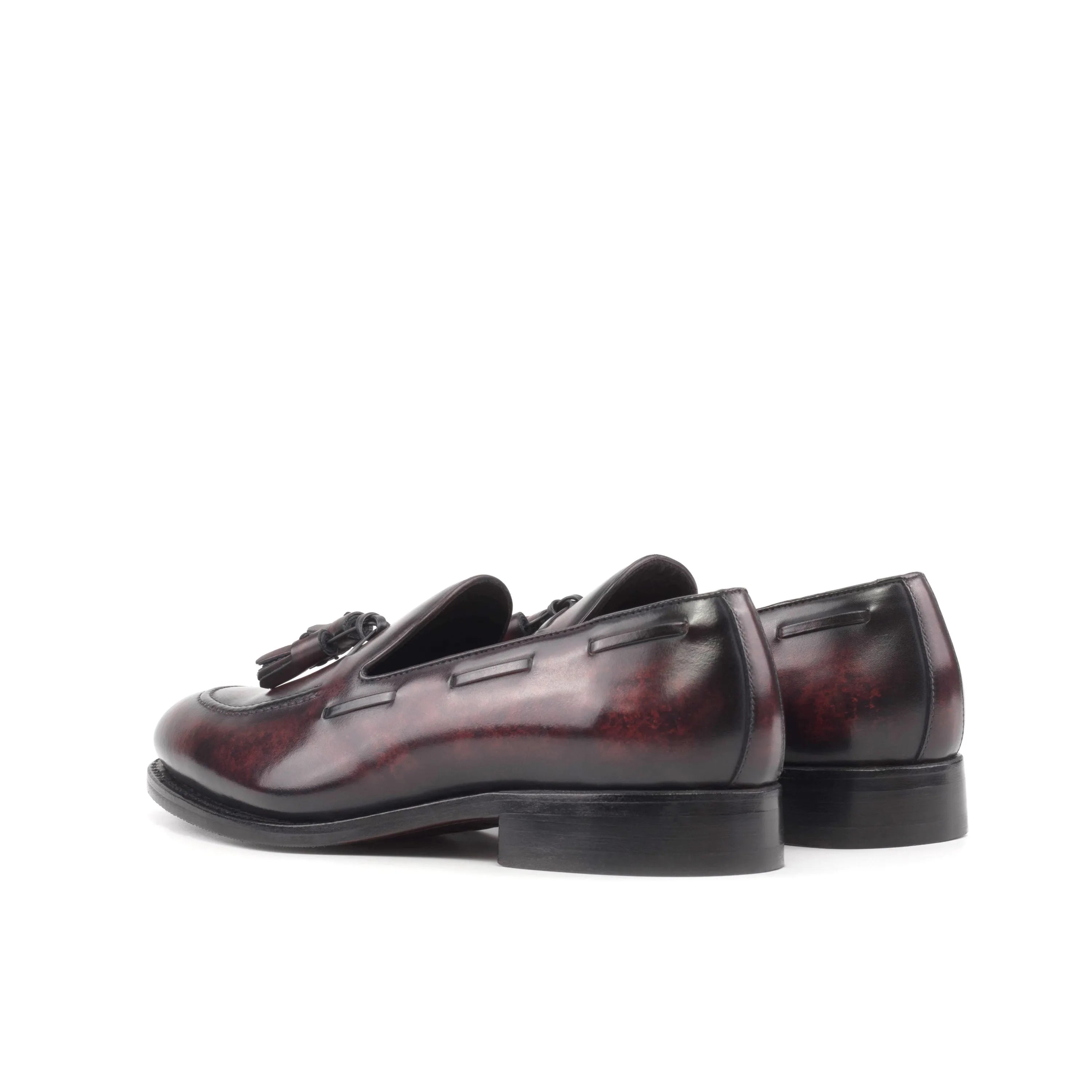 Burgundy leather tassel loafers from Enigma Patina, showcasing elegant patina craftsmanship