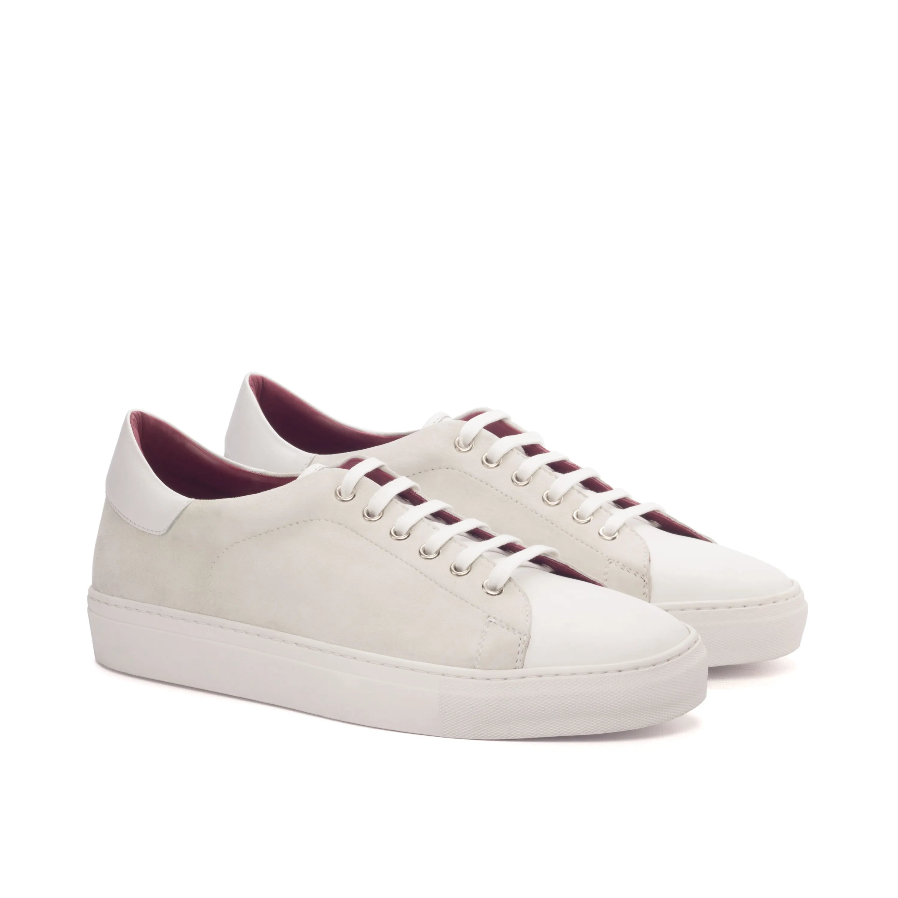 Pair of white leather sneakers, showcasing Evander Trainer Sneaker design
