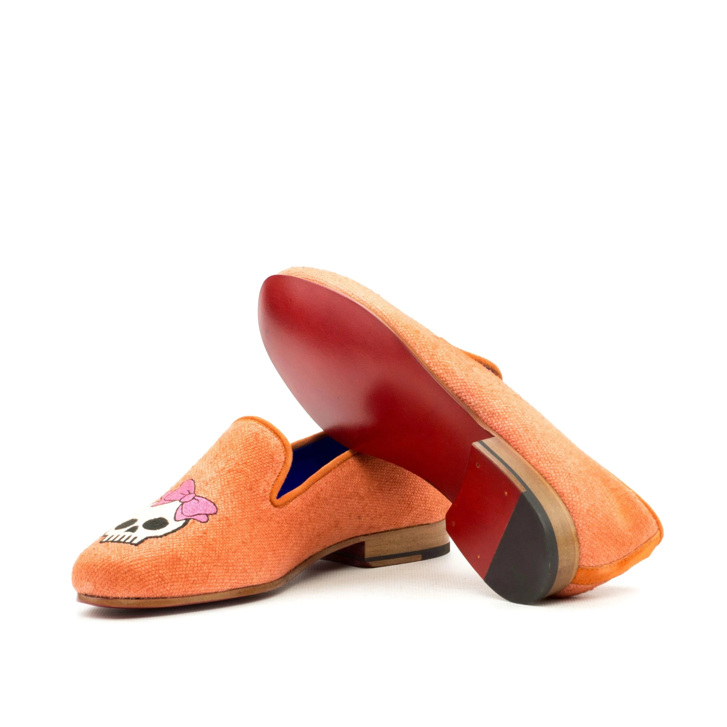 Orange suede Fero Womens Audrey Slipper featuring a skull and bow design