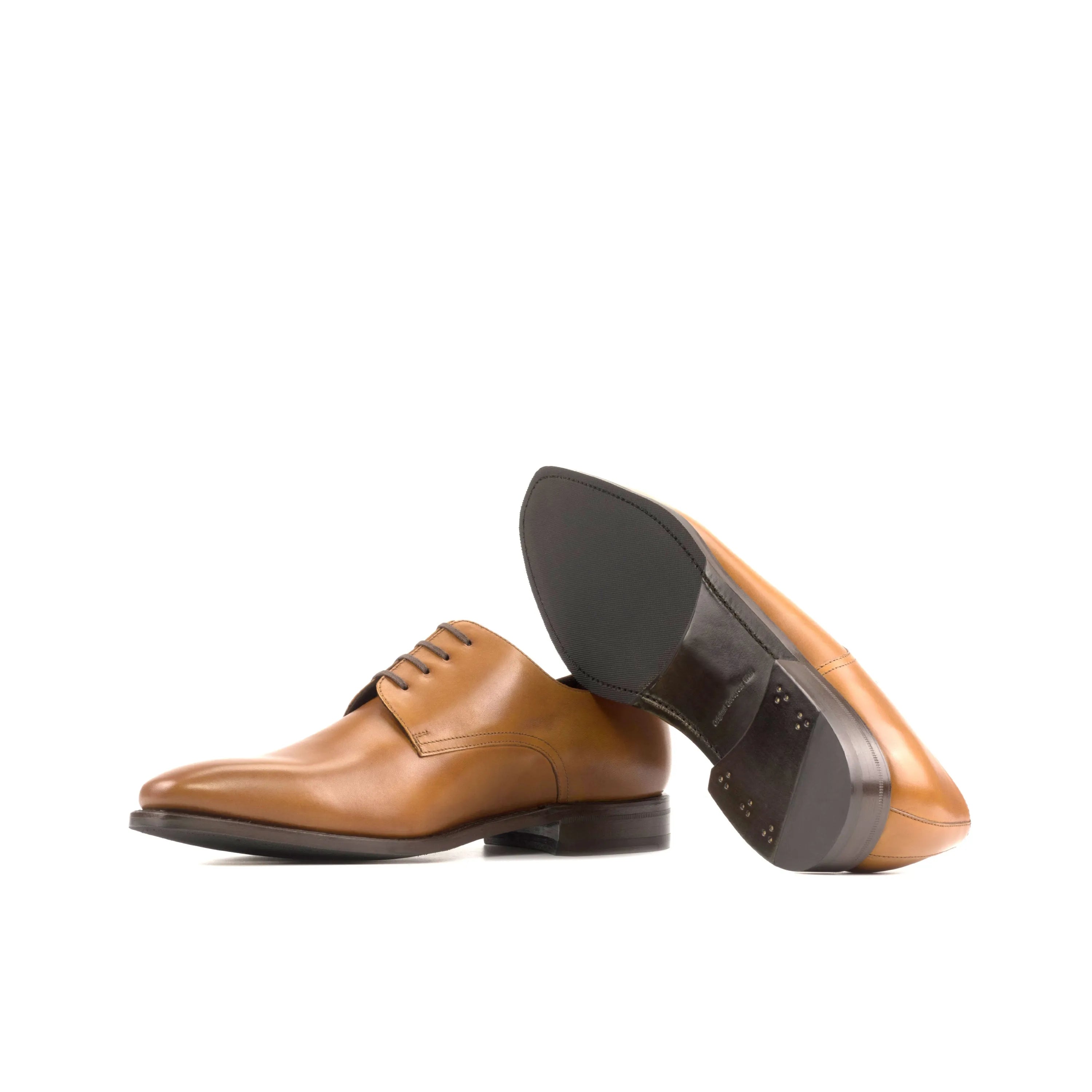Tan leather dress shoes, showcasing Fiolo Derby shoes, perfect for the fast lane lifestyle
