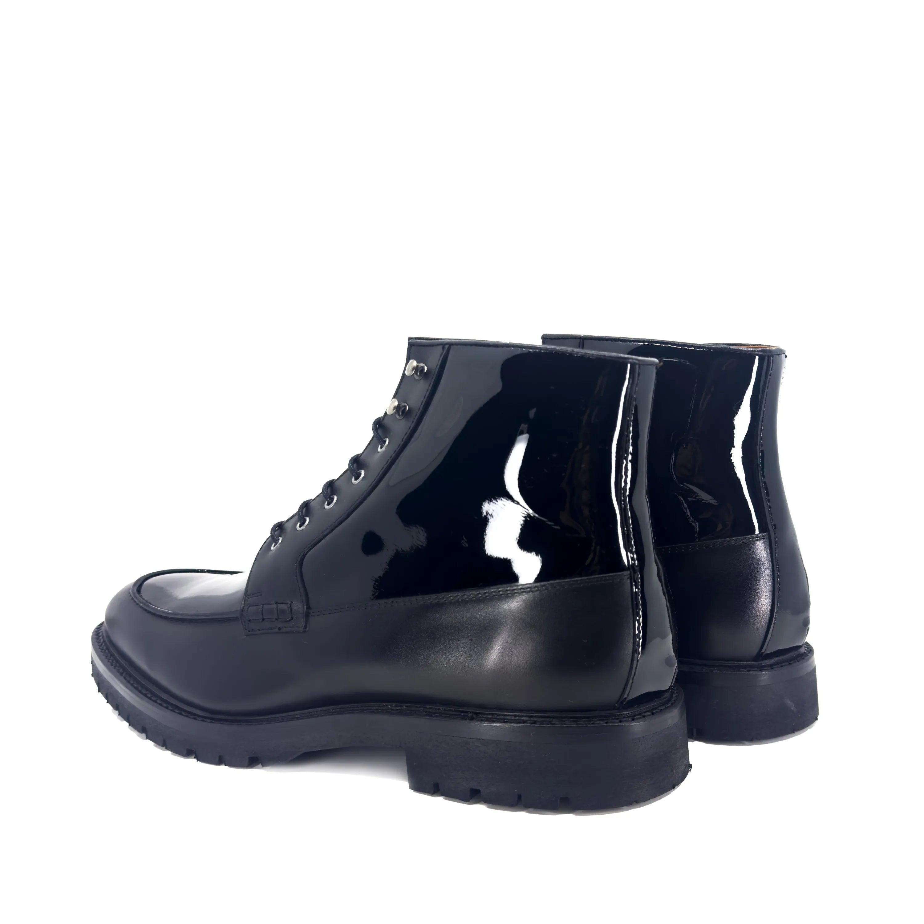 Pair of black patent leather Grandeur Moc Boots showcasing stylish footwear design