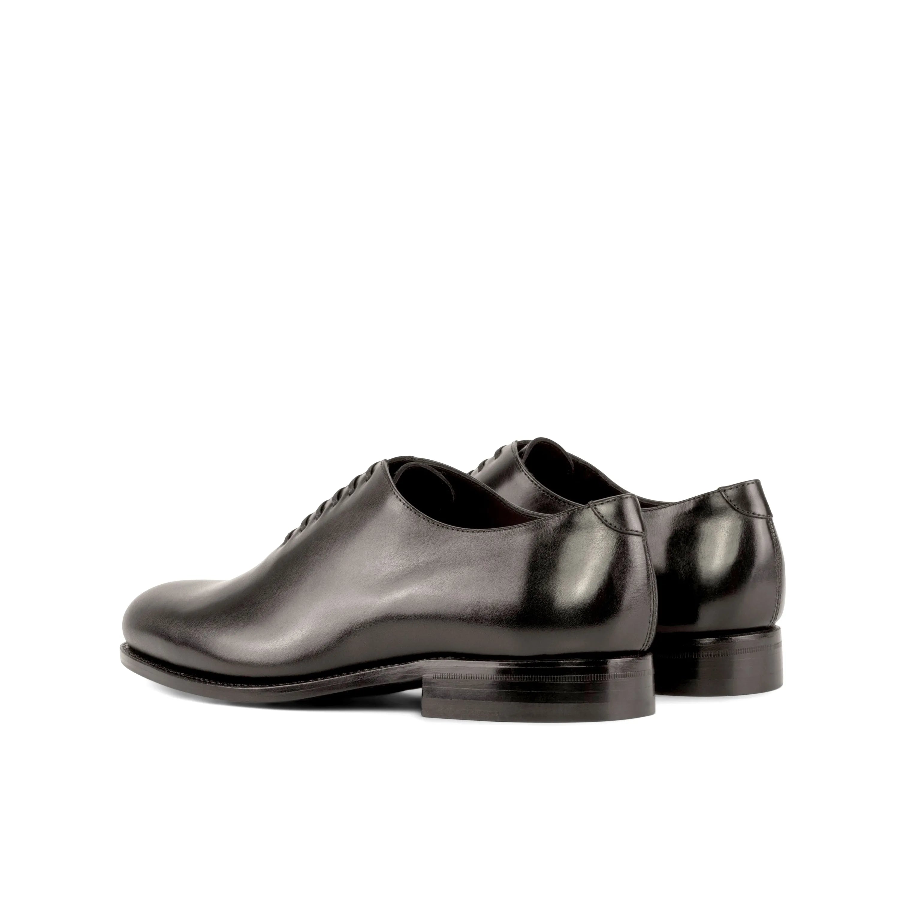 Pair of black leather dress shoes from Hans Wholecut showcasing elegant design