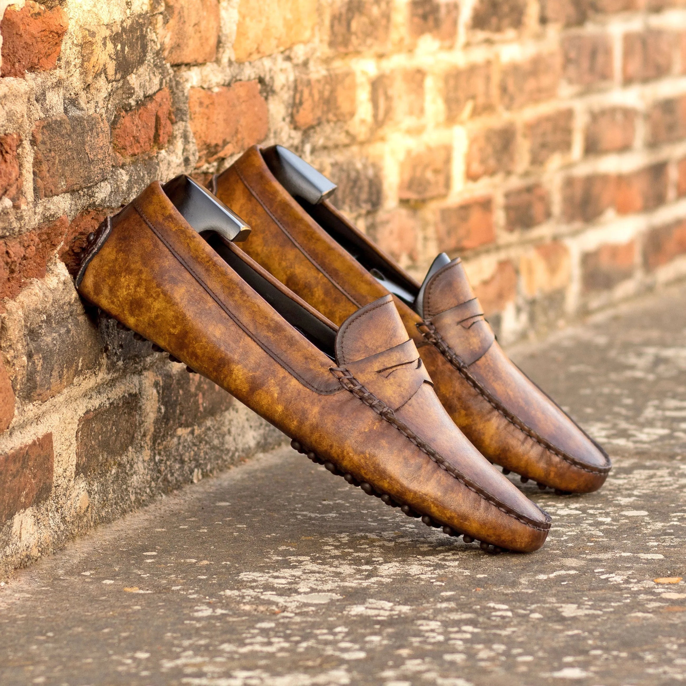 Brown leather penny loafers from Herolds Patina Driver, showcasing timeless elegance