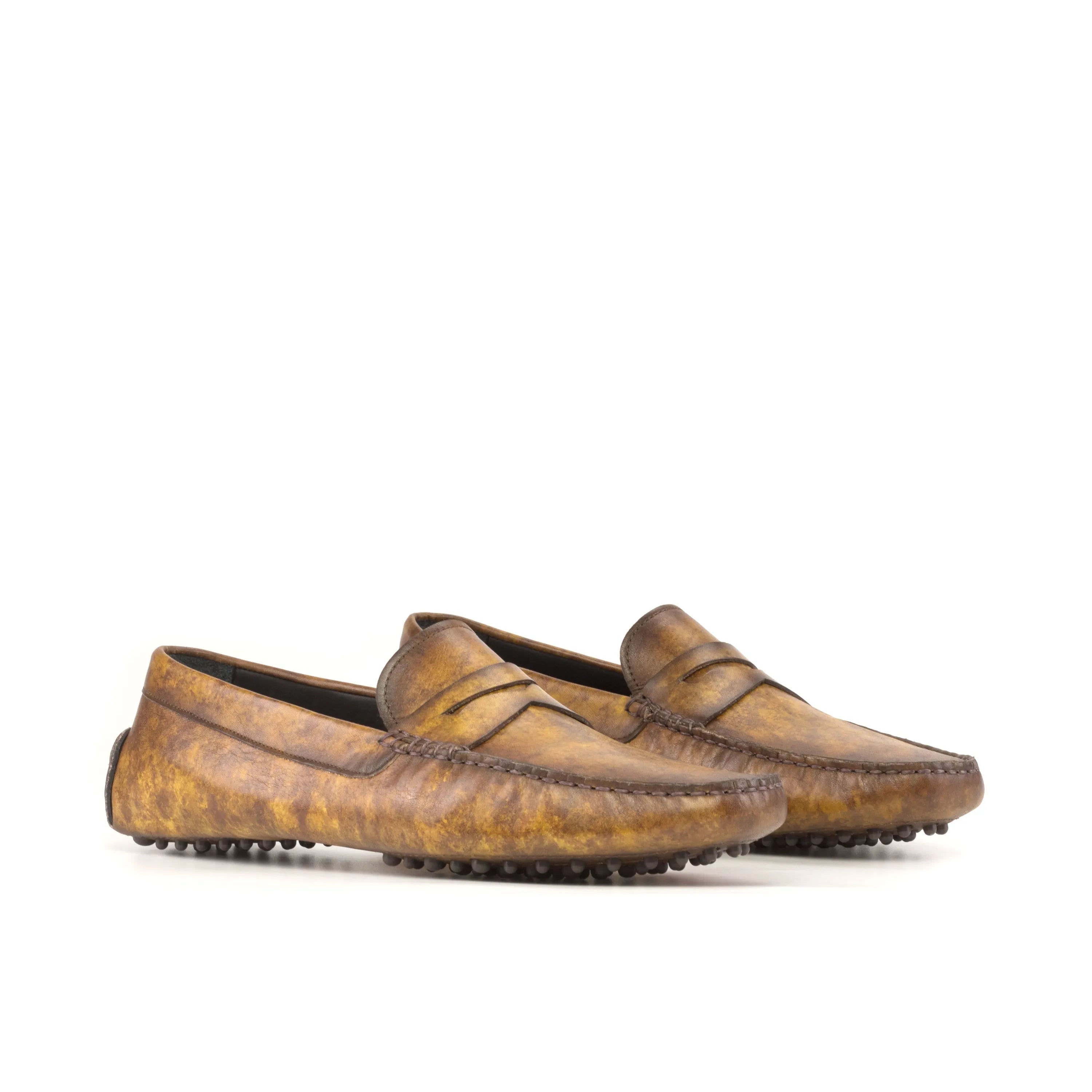 Pair of brown leather loafers from Herolds Patina Driver displayed elegantly