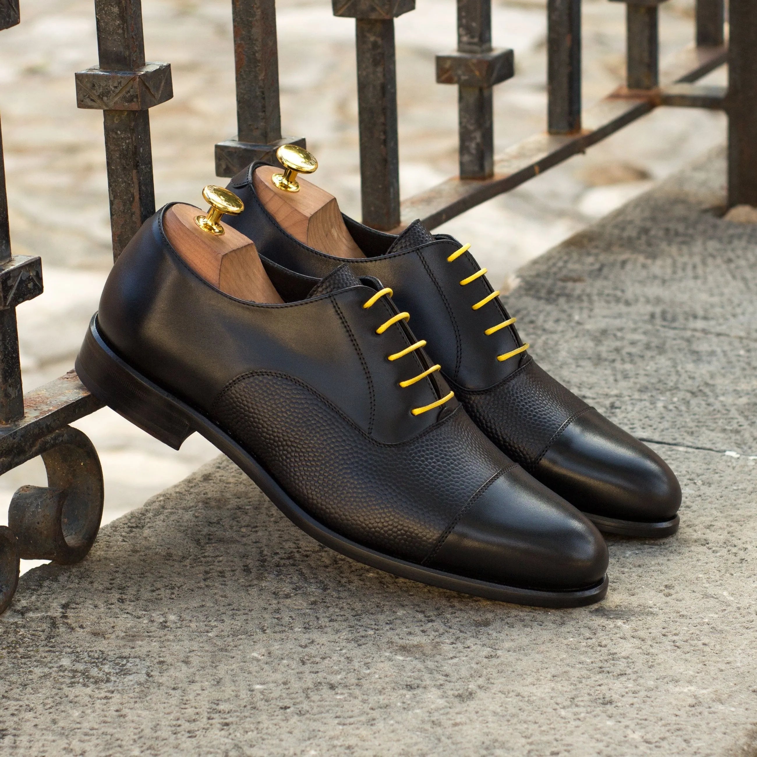 Black leather Honon Oxford Shoes featuring distinct yellow laces for a stylish flair