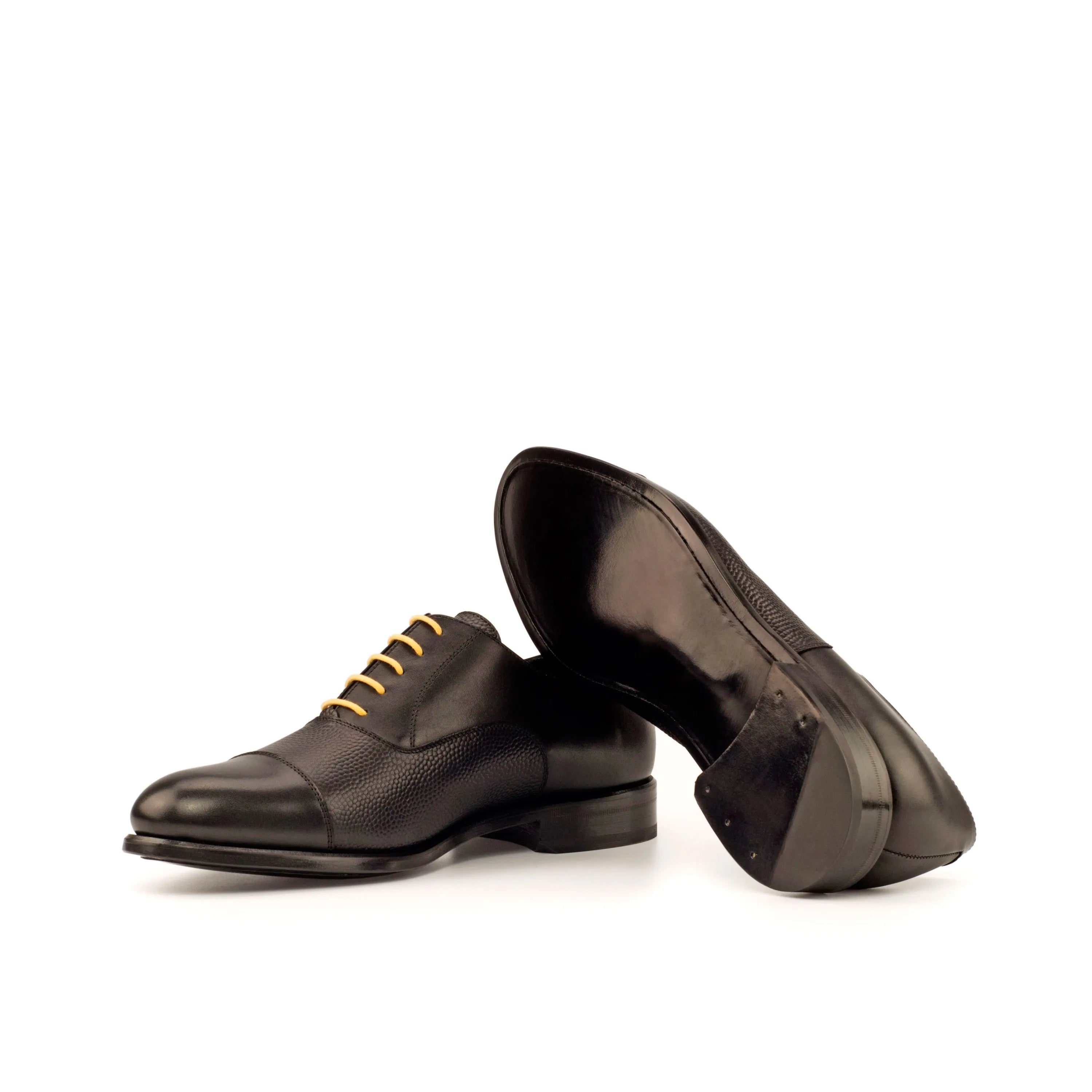 Pair of black leather Honon Oxford Shoes showcasing classic design and elegance