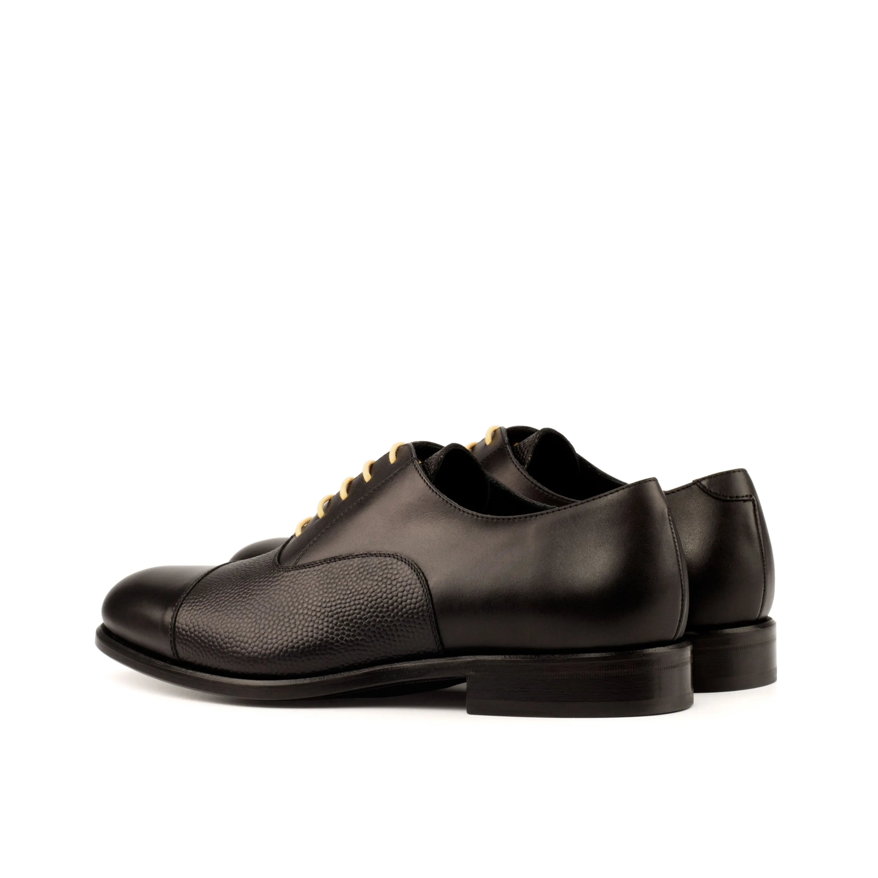 Pair of black leather Honon Oxford Shoes showcasing classic style and elegance