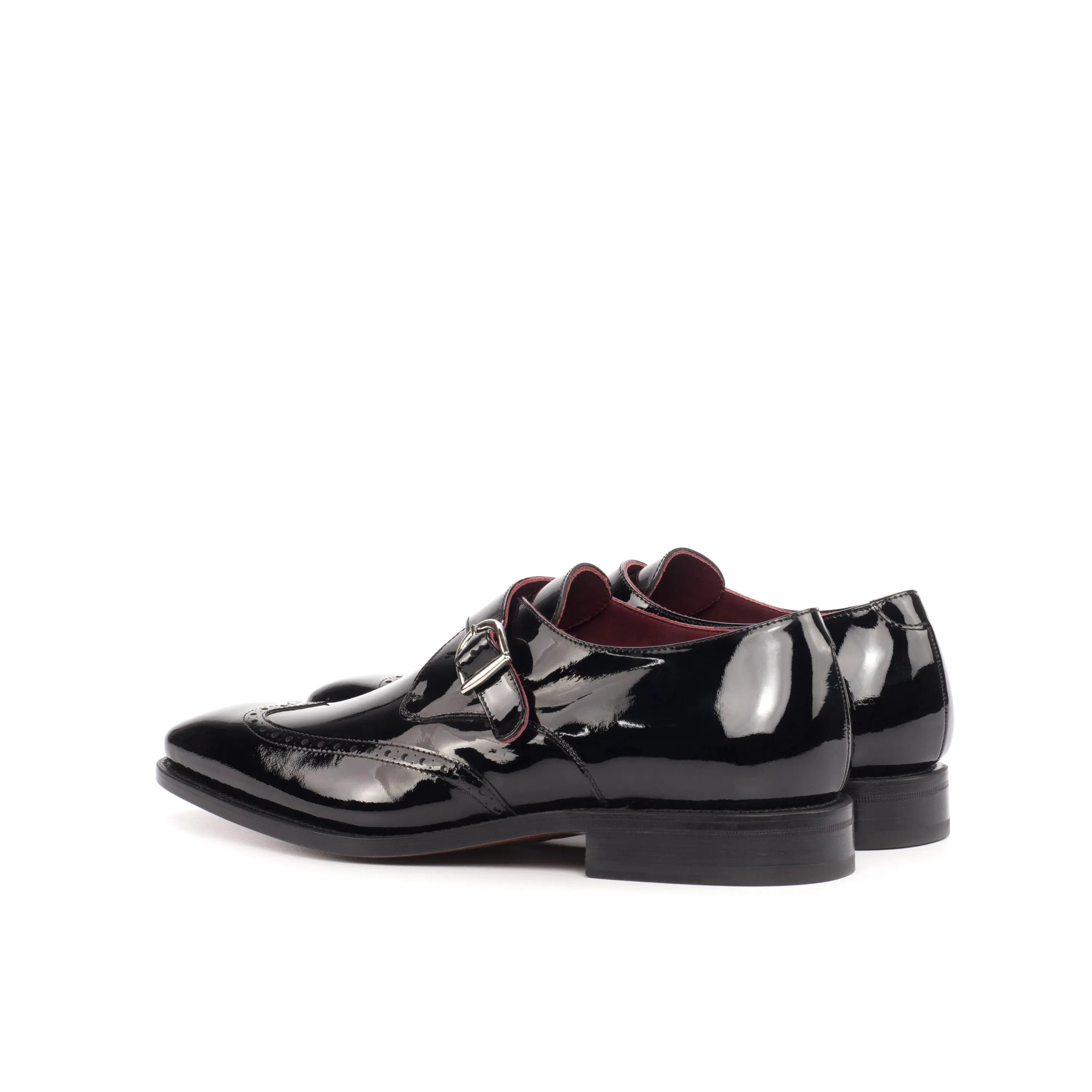 Pair of shiny black leather Hugh Single Monk Shoes featuring elegant craftsmanship
