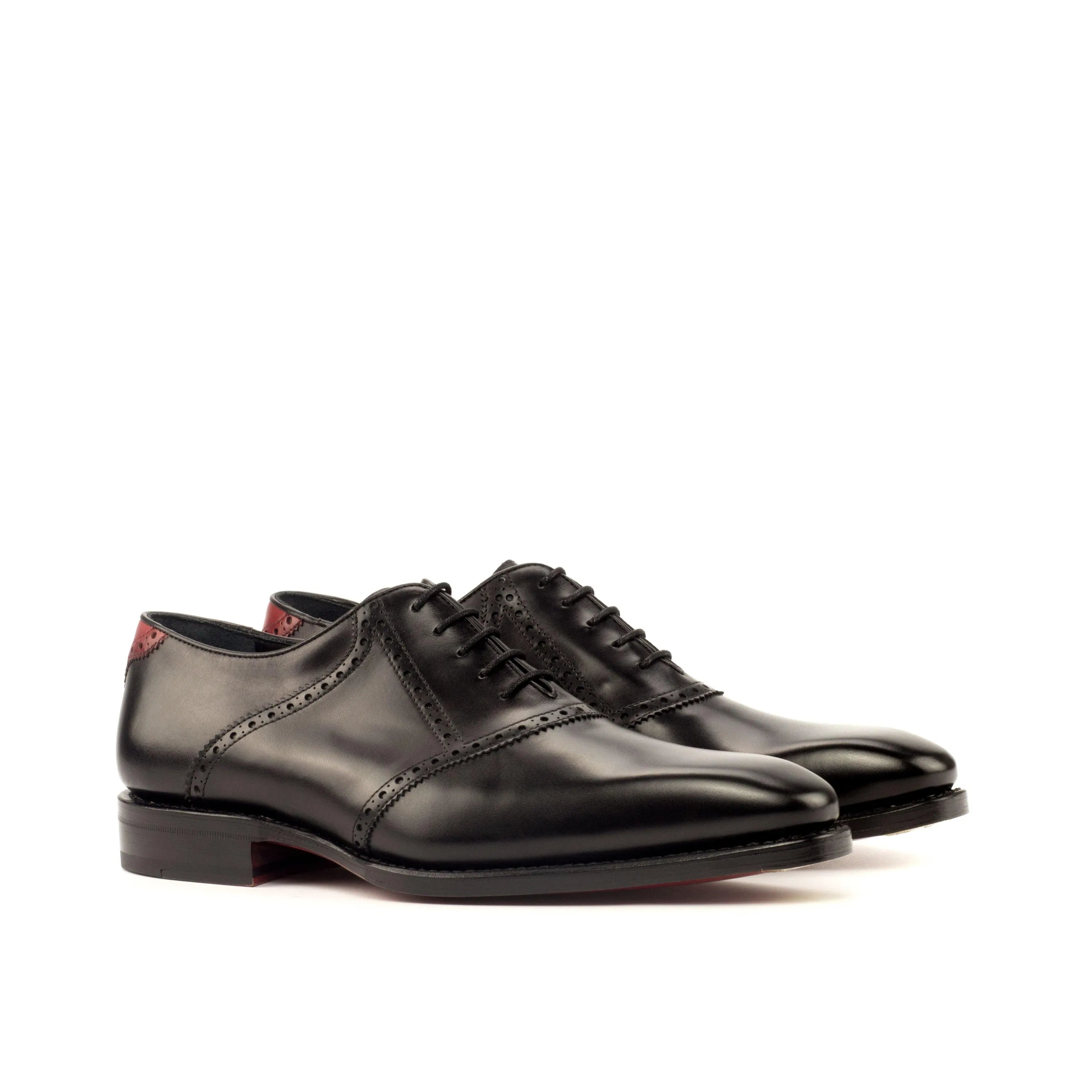 Pair of black leather Iron Saddle shoes featuring classic saddle design and elegance