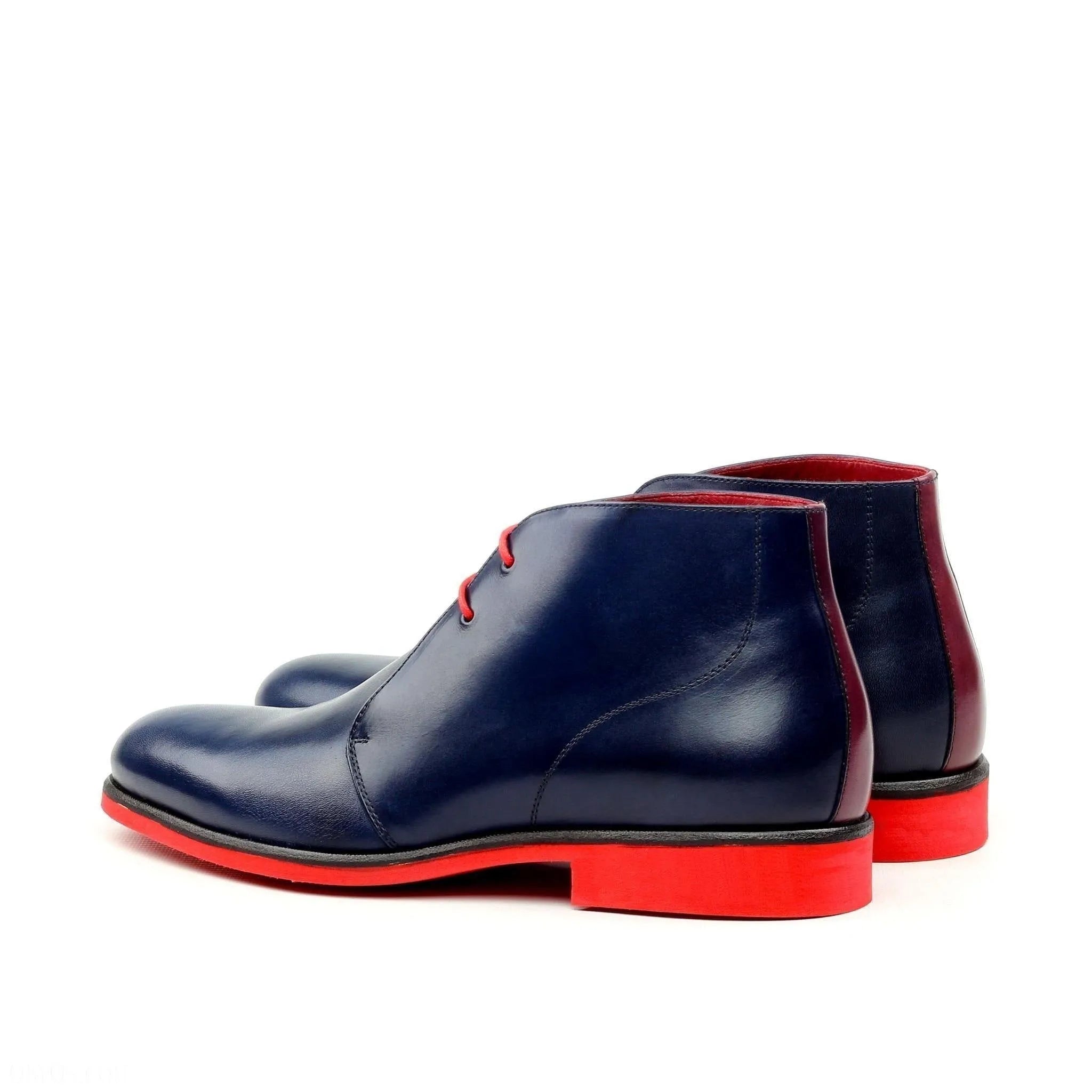 Blue leather Jean Chukka Boots featuring striking red soles for stylish comfort