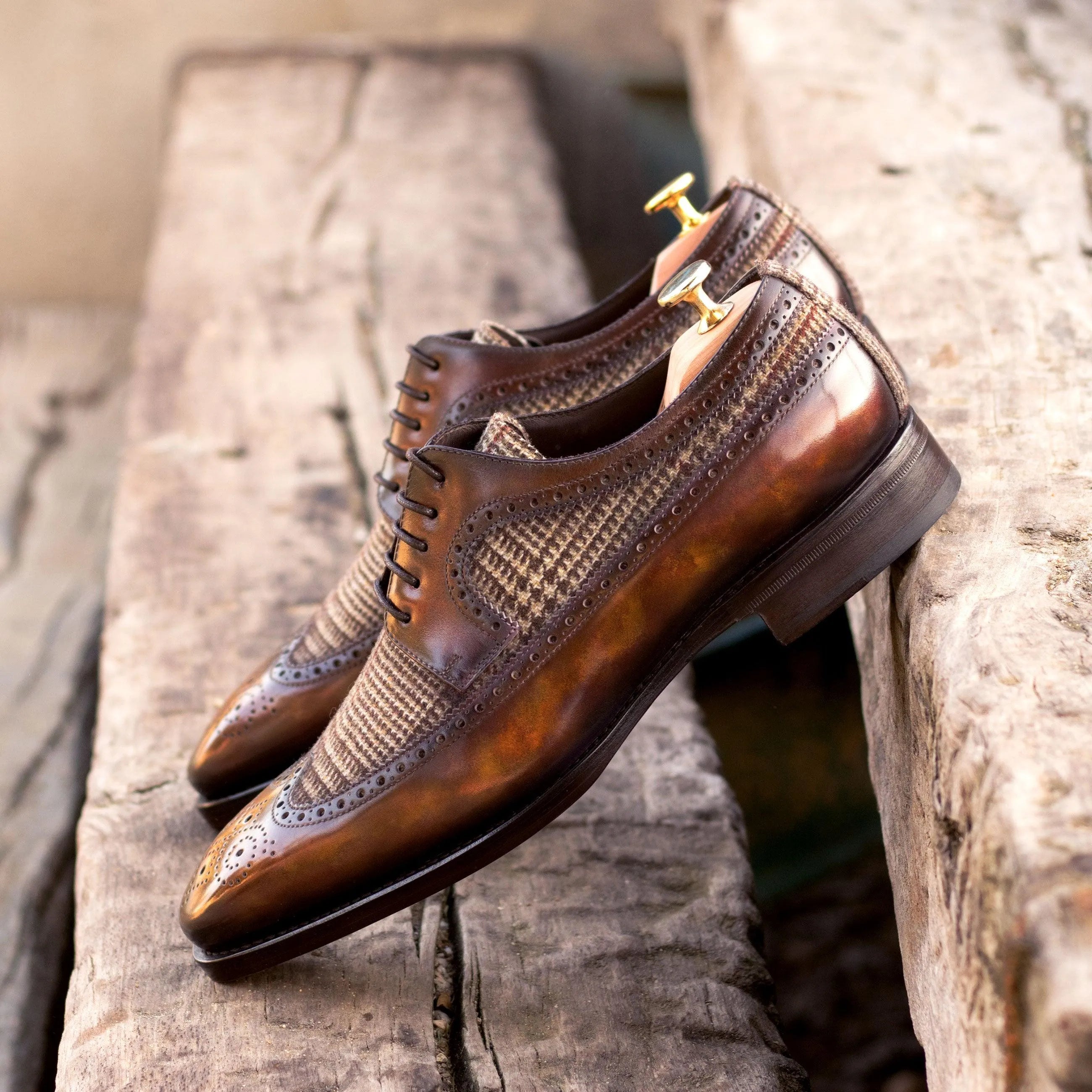 Brown leather dress shoes featuring the Junos Patina Longwing Blucher design