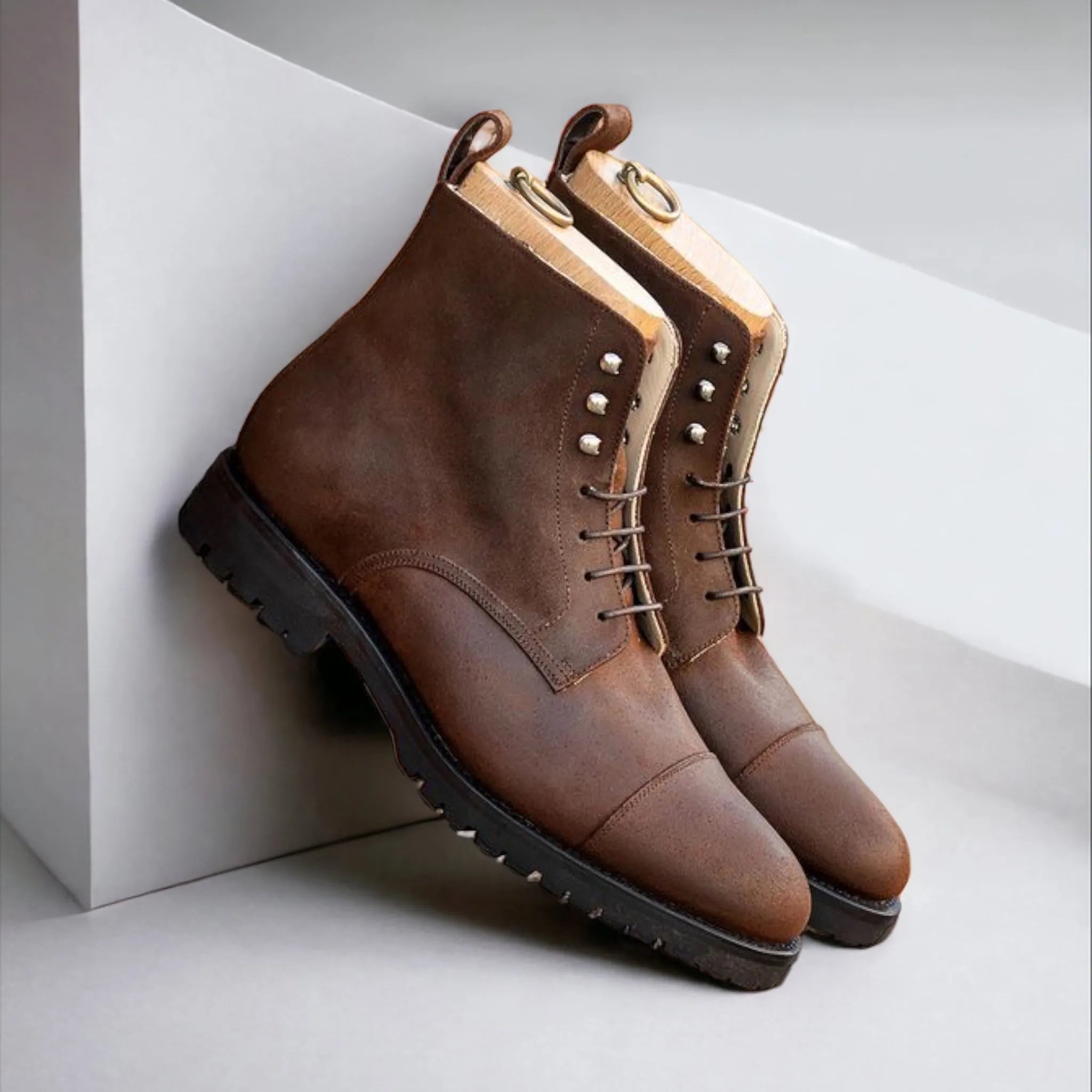 Brown leather cap-toe boots featured in Lasamo Jumper Boots product display