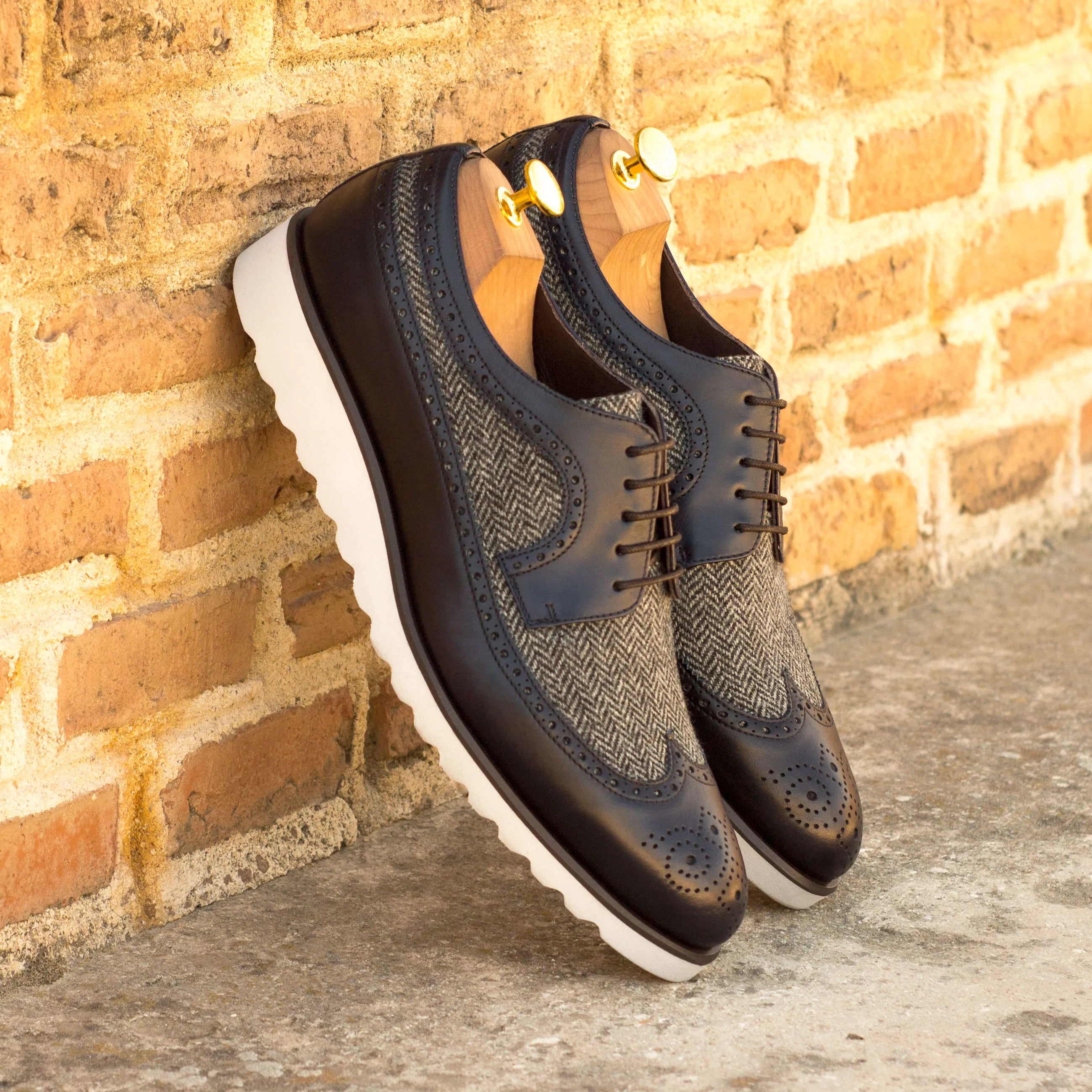 Two-tone leather and tweed Livius Longwing Blucher wingtip shoes displayed elegantly