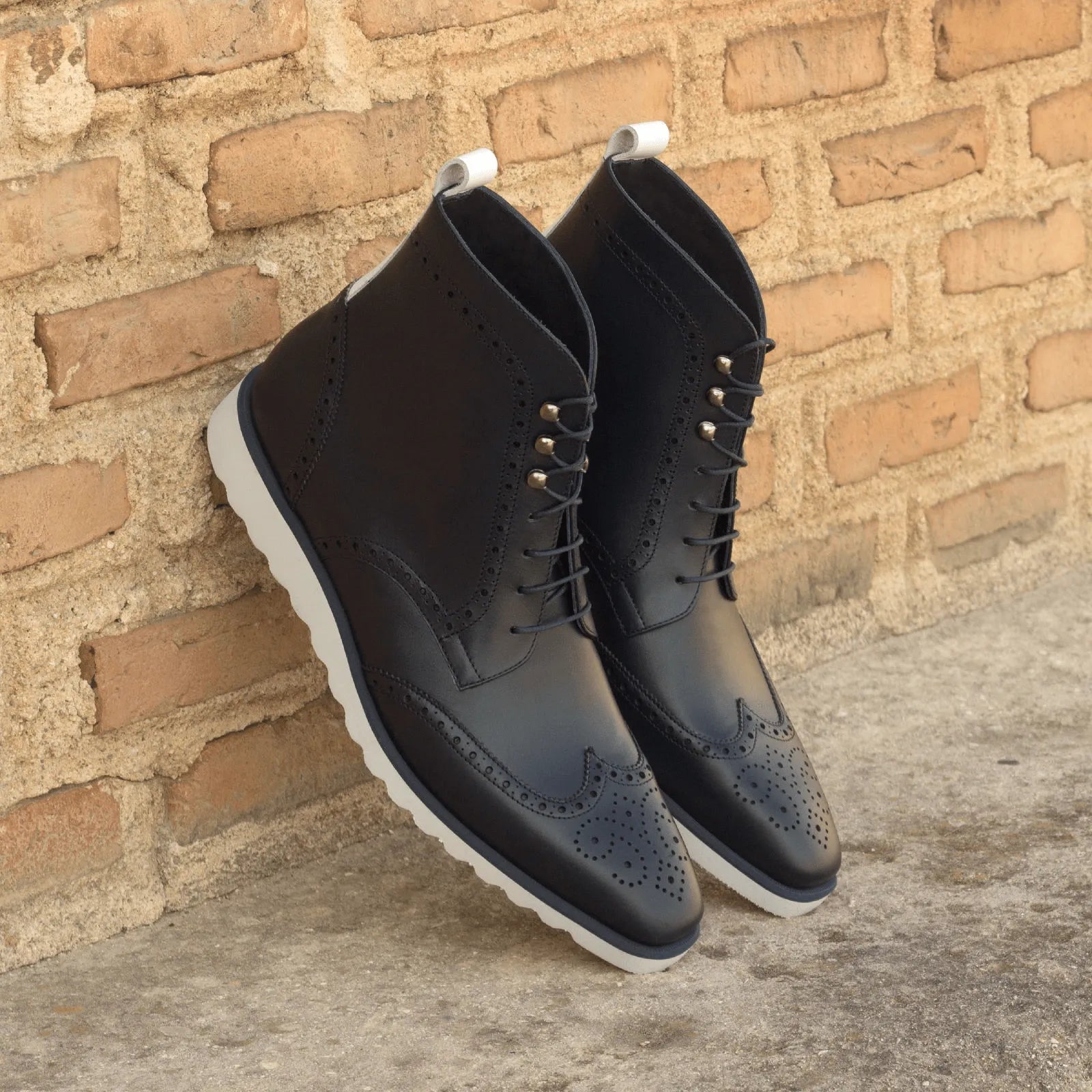 Black leather Wingtip Boots showcased as Lovita Military Brogue Boots in Box Calf finish