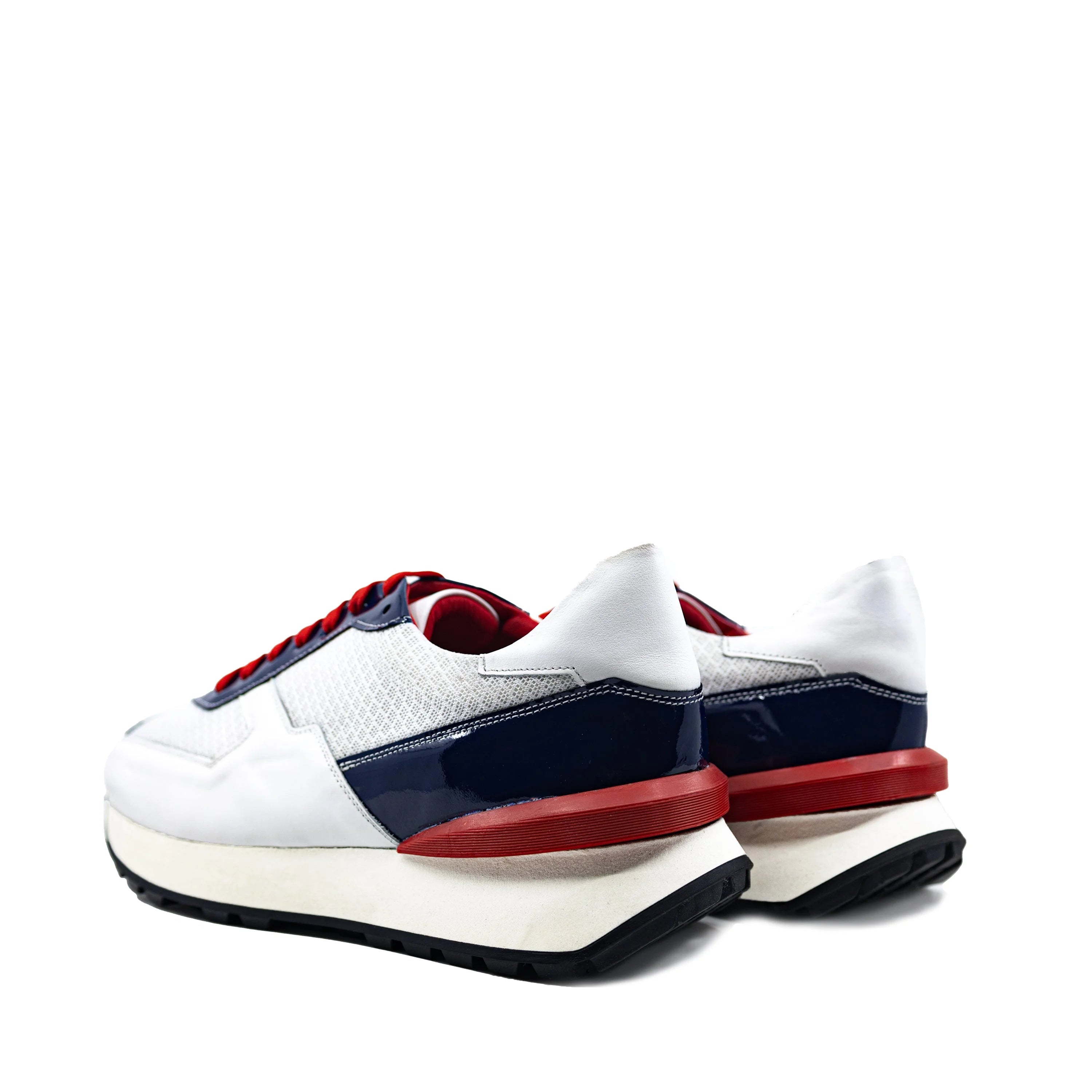 M9 Chunky Tempo Trainer Sneaker in white, navy blue with red accents, exaggerated proportions, cushioned soles