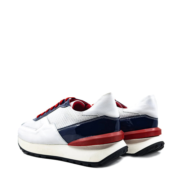M9 Chunky Tempo Trainer Sneaker in white, navy blue with red accents, exaggerated proportions, cushioned soles