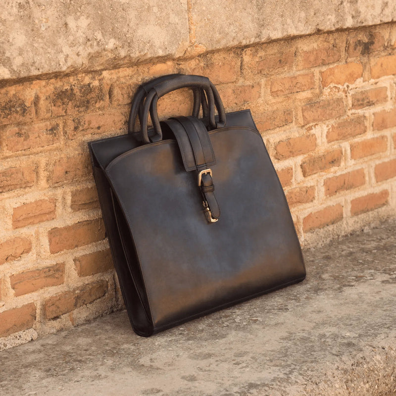 Black leather Machino briefcase with buckle showcasing unique savoir-faire and painted calf