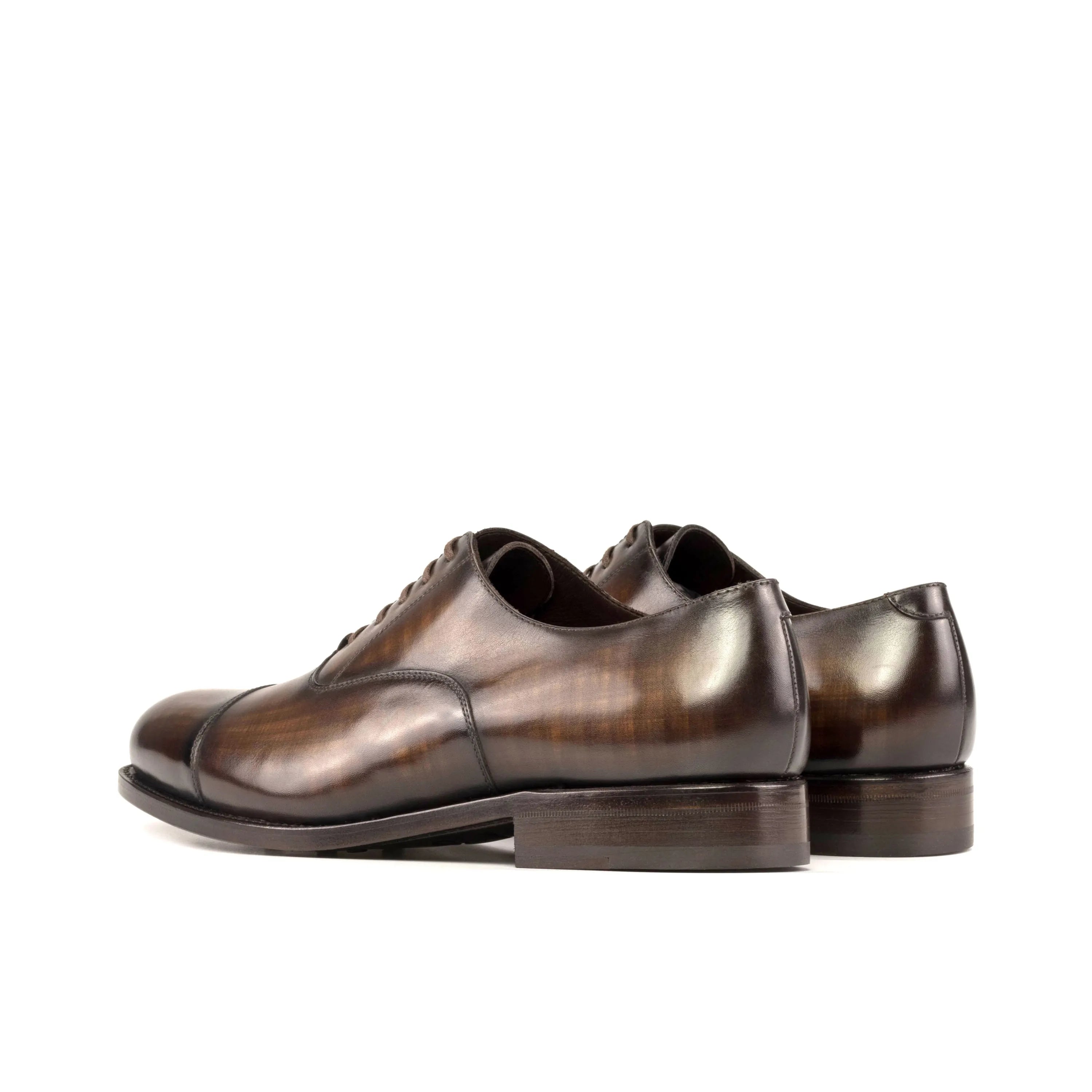 Pair of brown leather Mavrick Patina Oxford shoes displayed elegantly