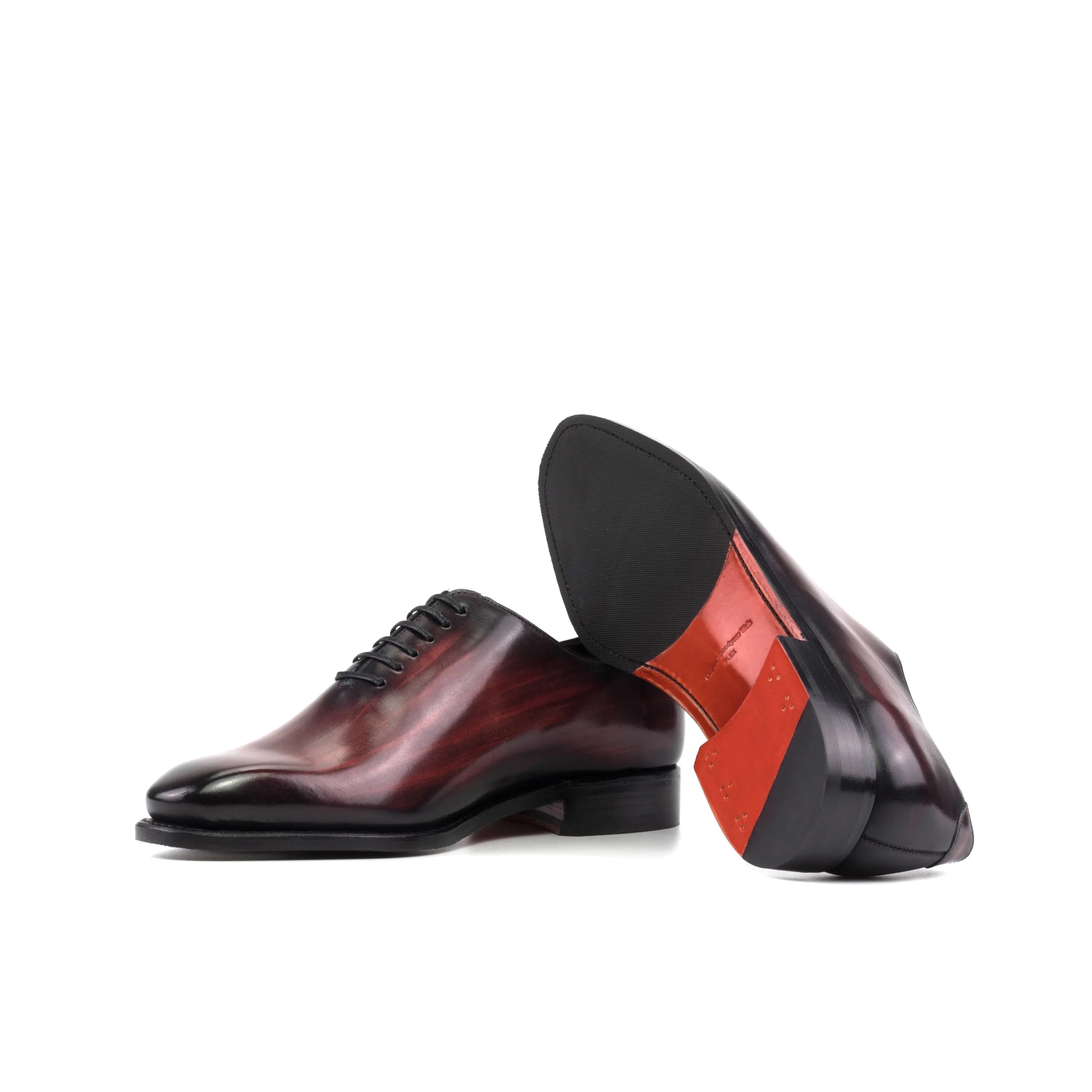 Burgundy leather Mercure Patina Wholecut shoes elegantly displayed in a professional setting