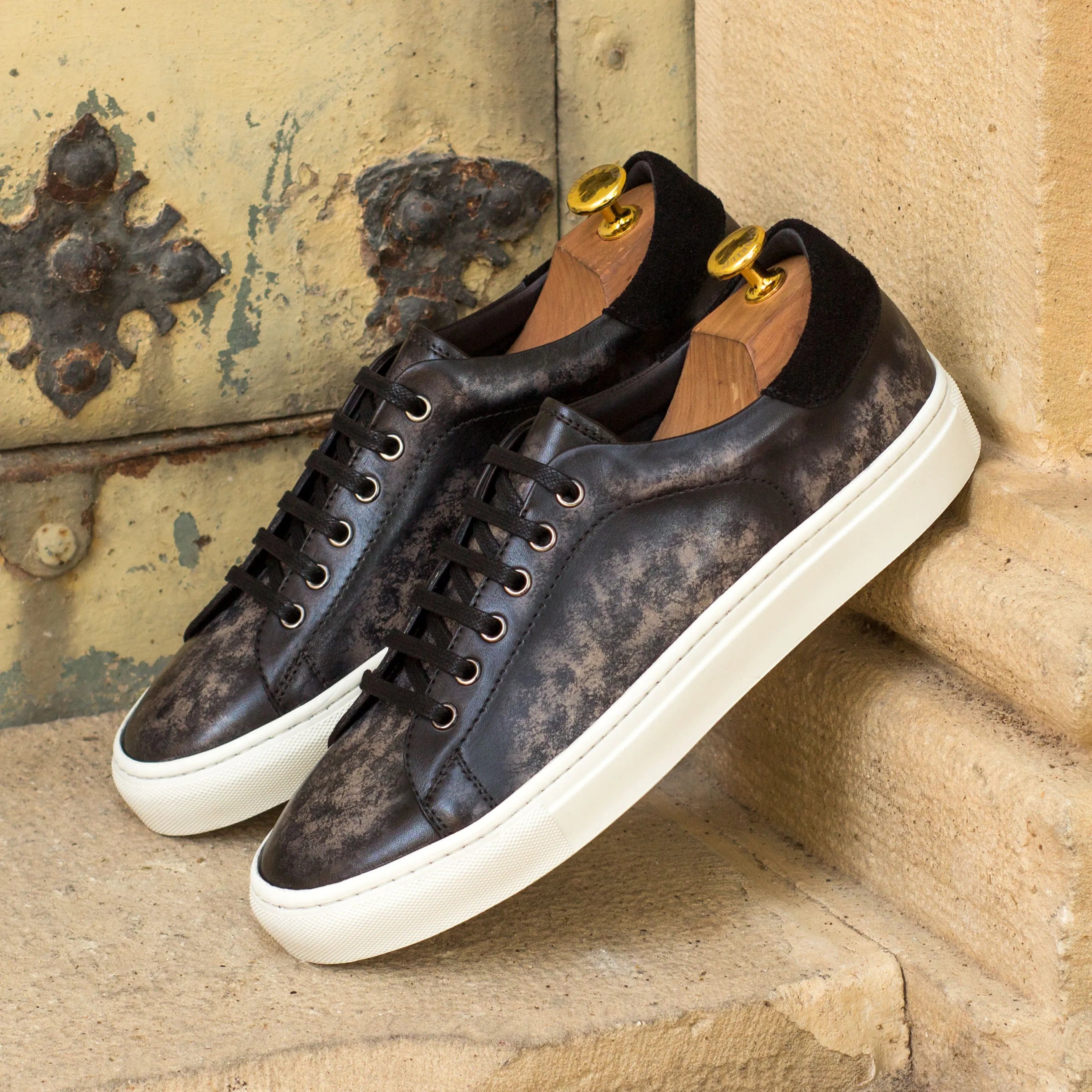 Leather Nira Trainer Patina Sneakers displayed with shoe trees for optimal preservation