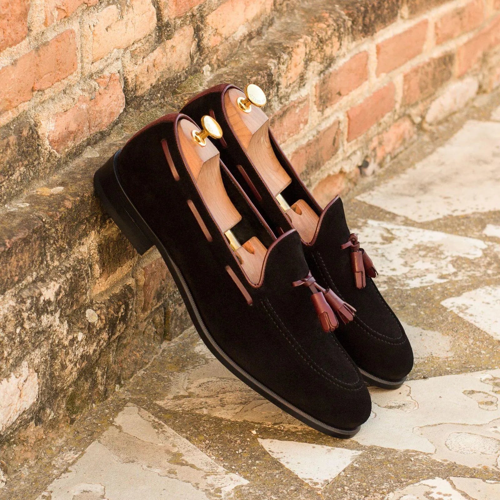Pair of Nonda Loafers II in black suede featuring a rounded toe and elegant tassel detail