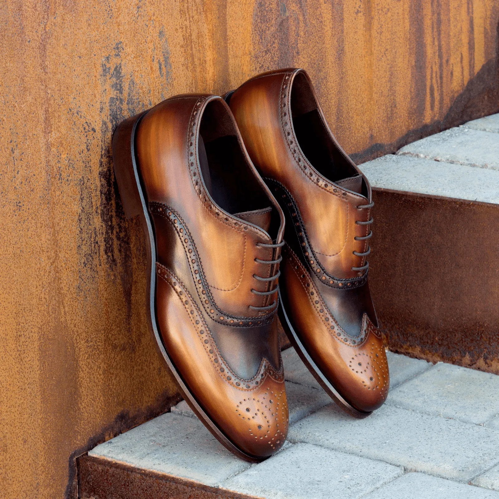 Pair of brown leather brogue shoes, showcasing elegant NY Full Brogue Patina design