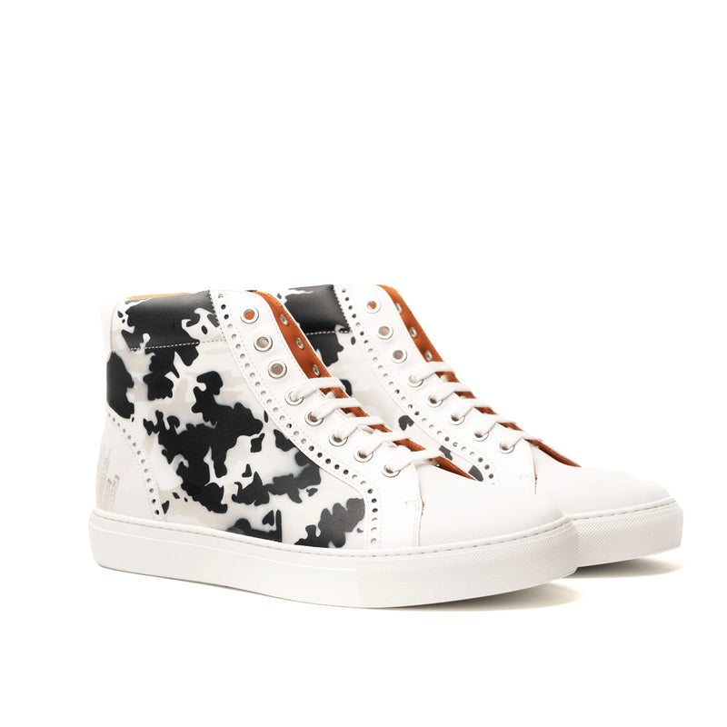 White high-top NYC High Kicks Sneakers II featuring black cow print design
