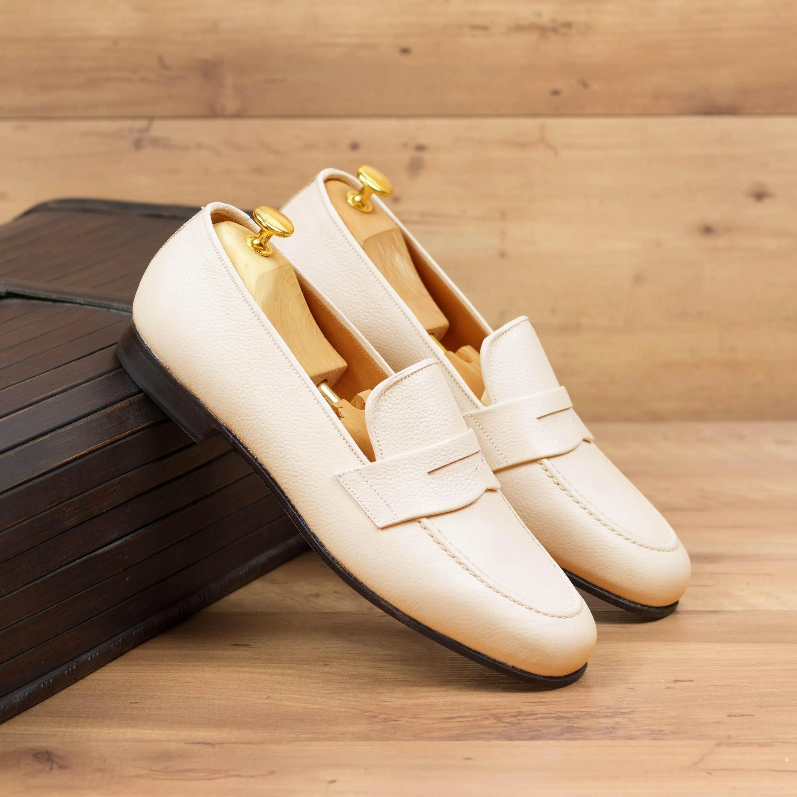 Cream-colored leather loafers from the Olgo Wellington slip collection