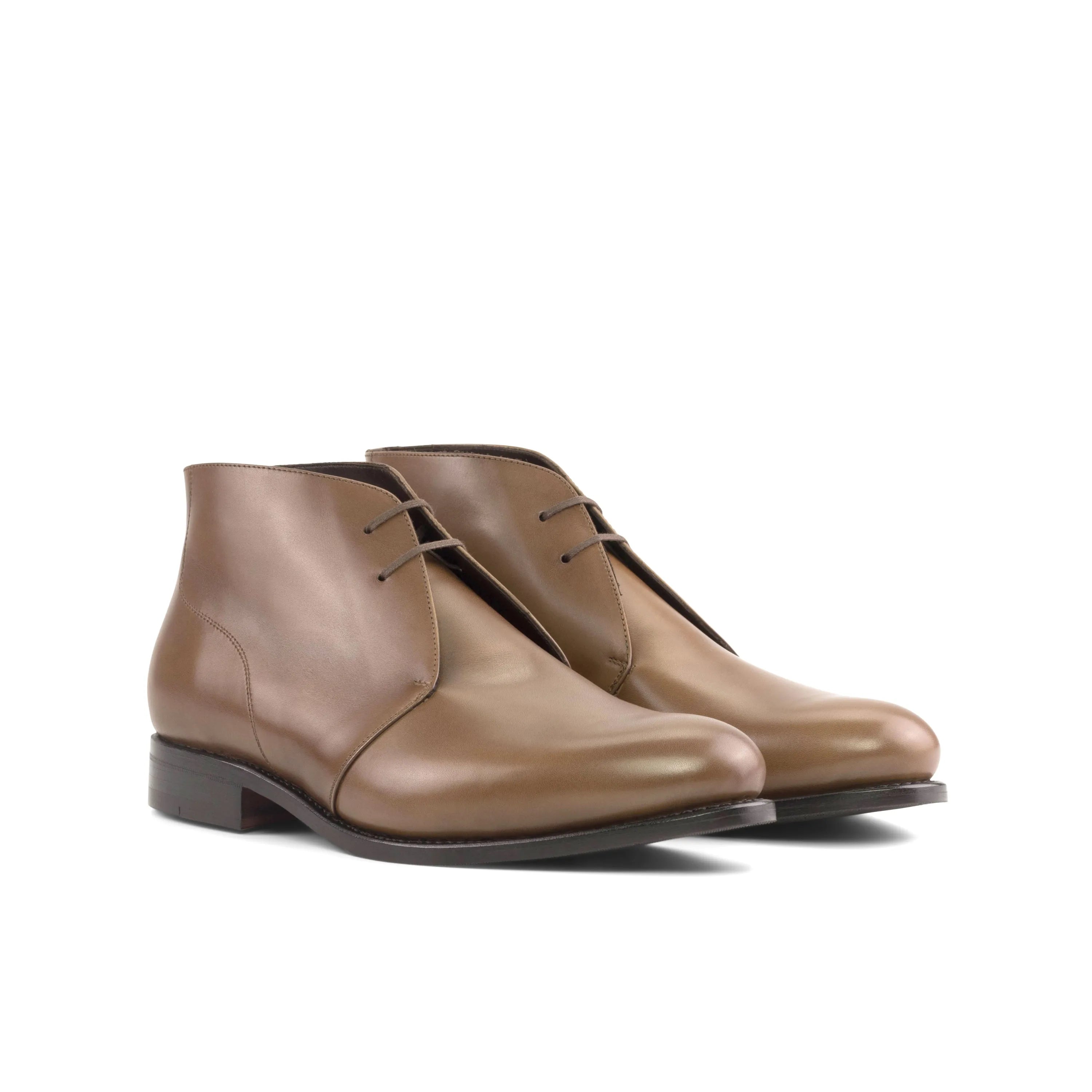 Brown leather Olian Chukka Boots displayed in a stylish arrangement for fast lane fashion