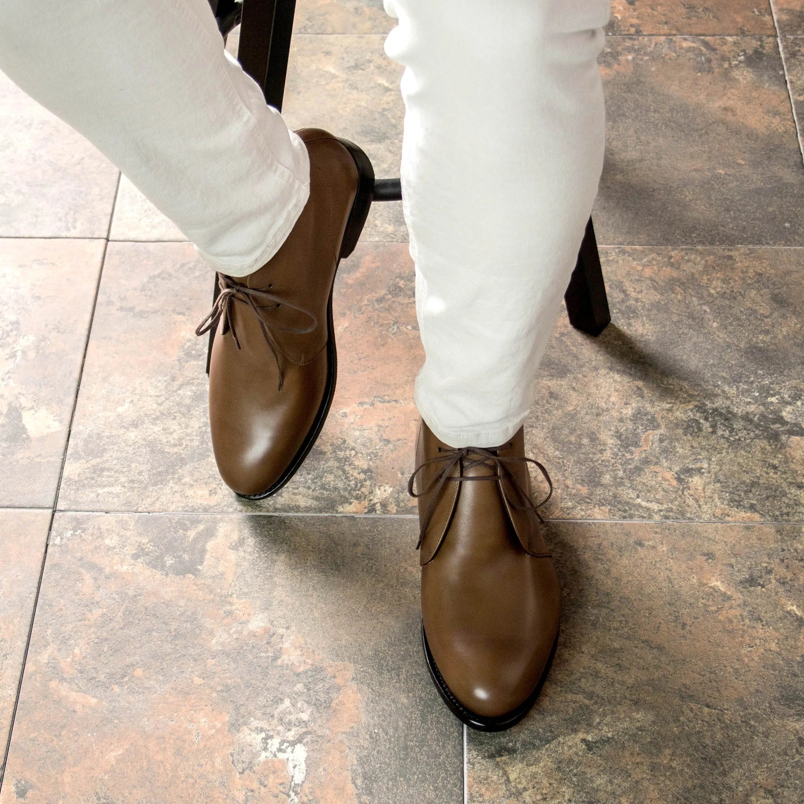 Brown leather Olian Chukka boots displayed elegantly in a stylish setting
