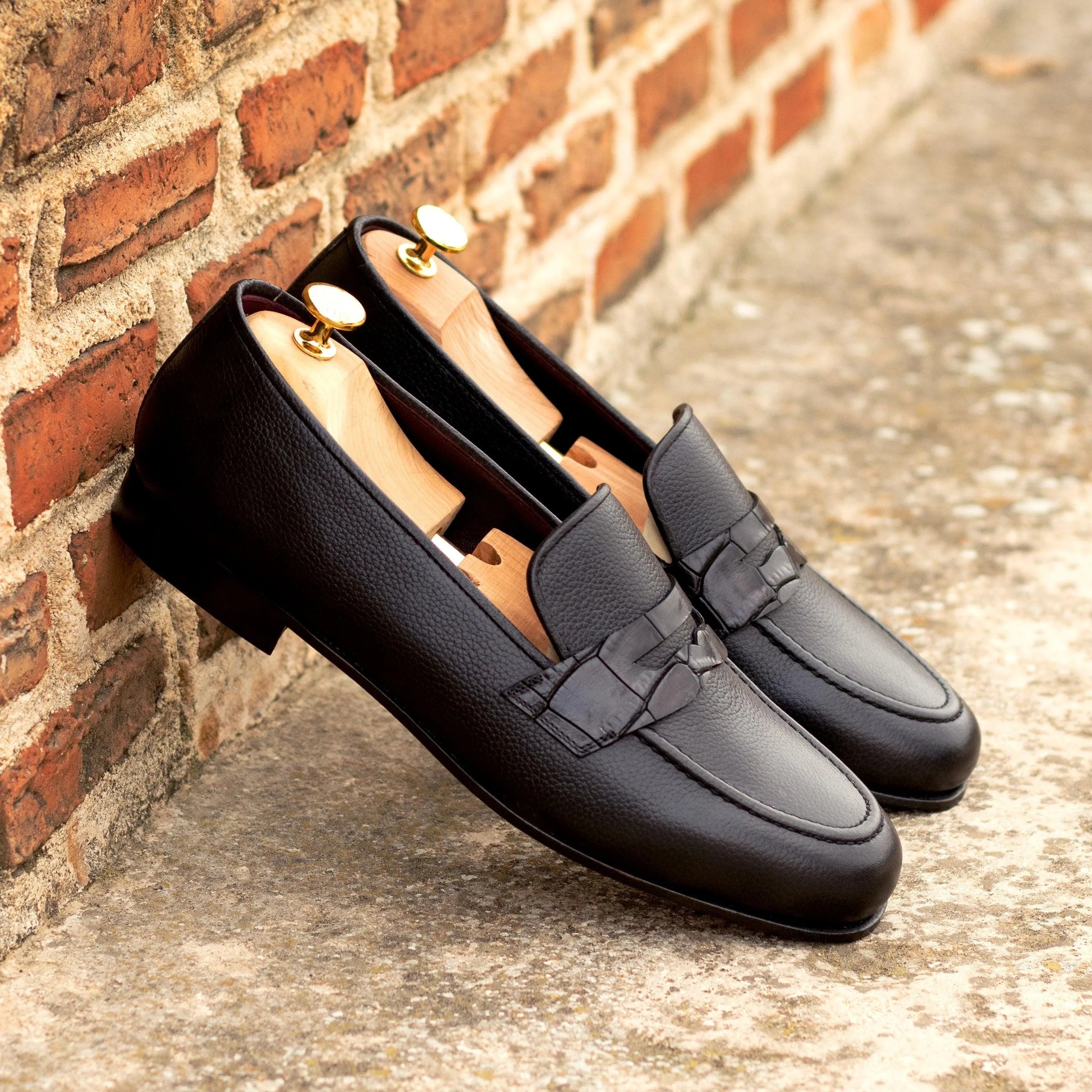 Black leather penny loafers from the Patron Wellington slip collection