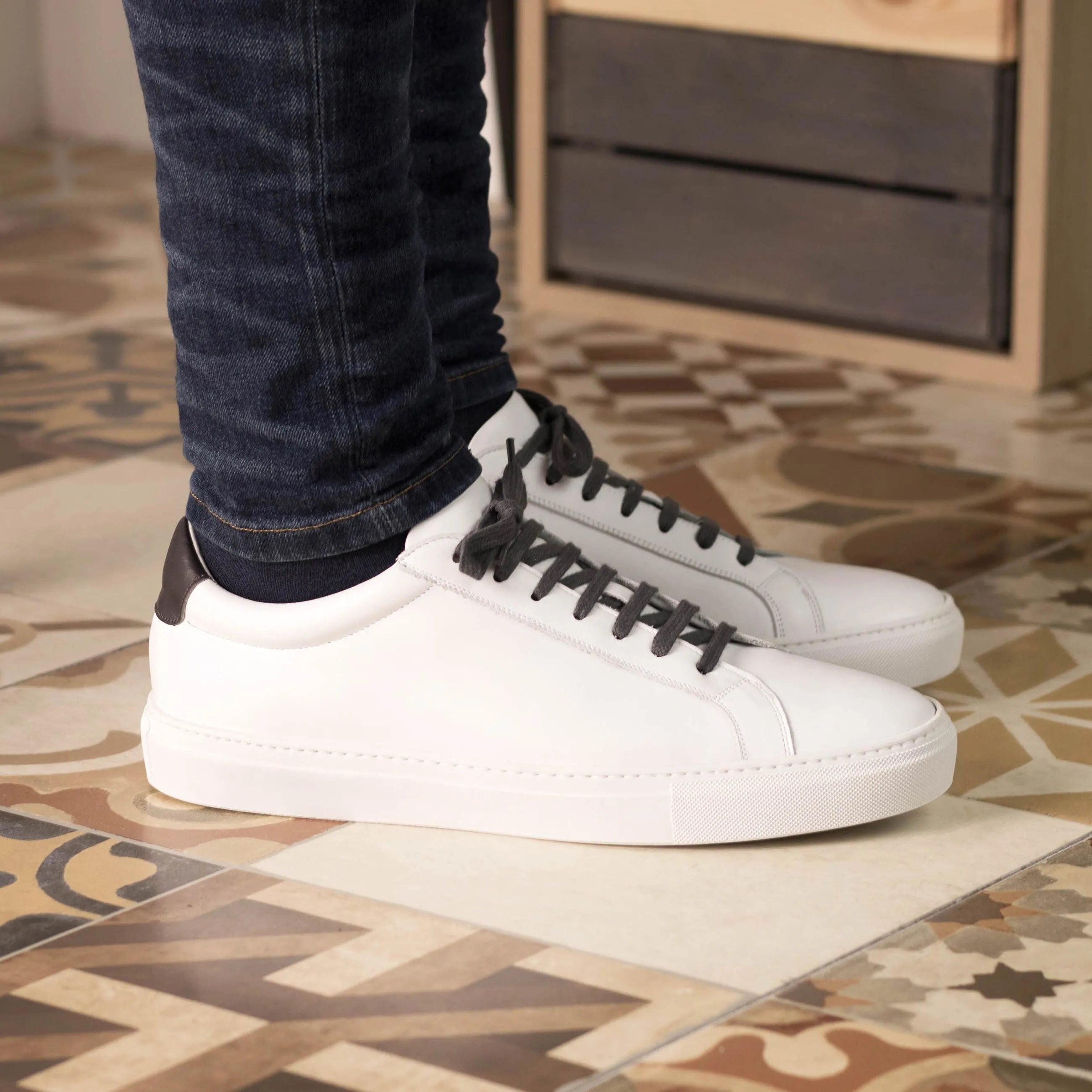 White leather Pauli low kick sneakers featuring dark laces for a stylish fast lane look