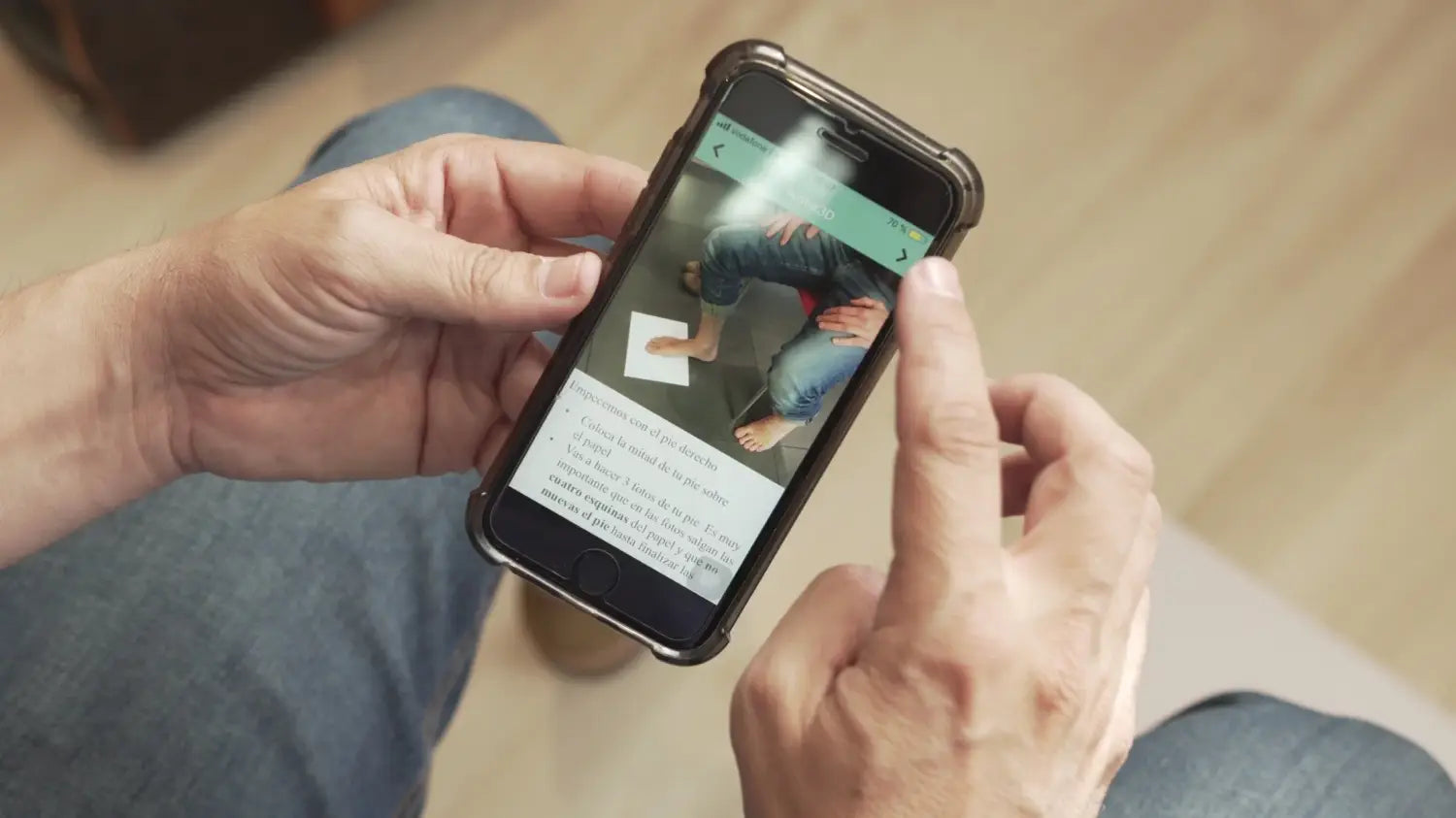 Person holding smartphone using feet scan and size app for perfect Patina Chelsea Boots.