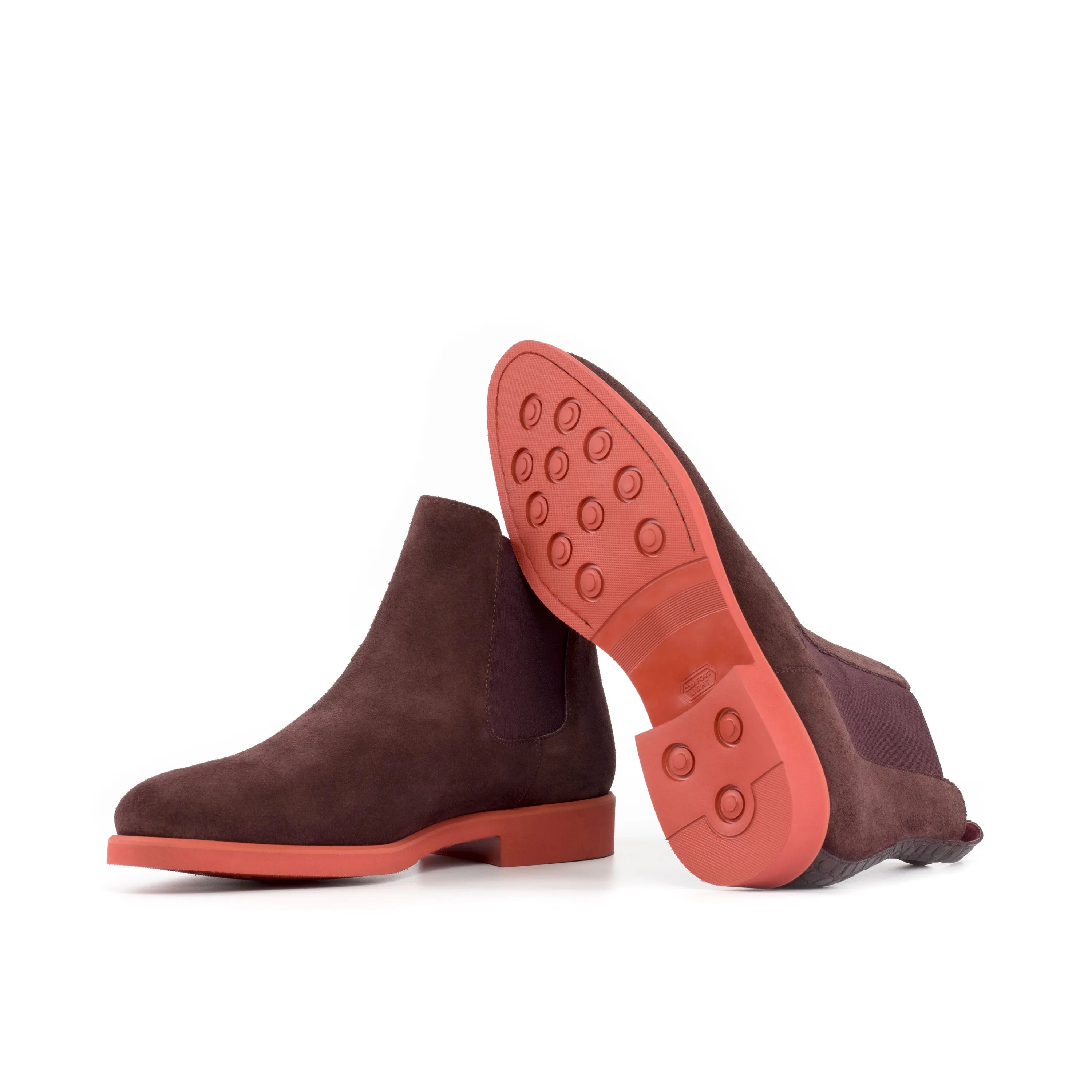 Brown suede Poppy Chelsea suede boots featuring distinct red soles for stylish elegance