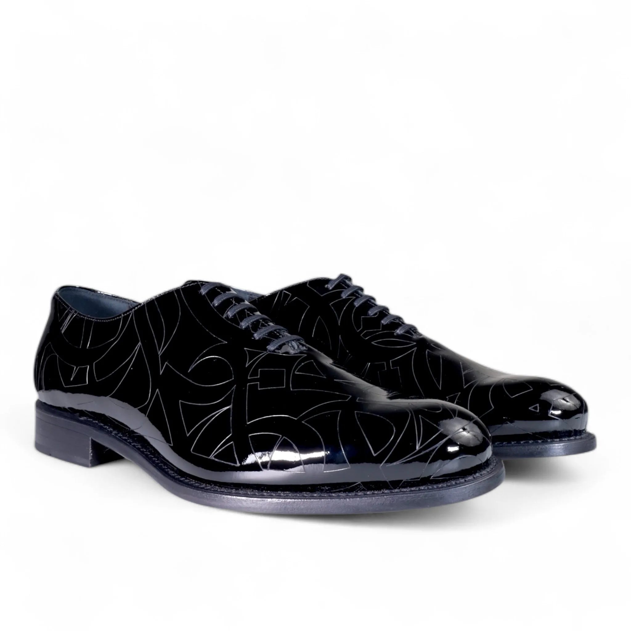 Black patent leather Quswa Noir Wholecut Shoes from the Cleopatra Edition display