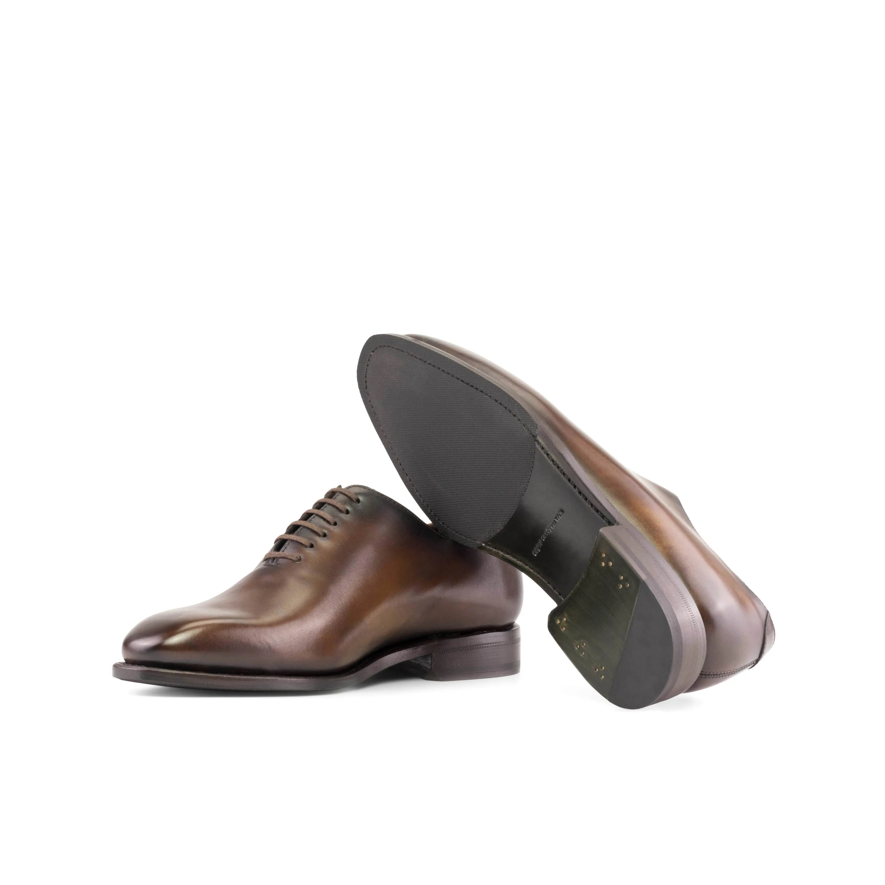 Pair of brown leather dress shoes showcasing Renzo Wholecut shoes style and sophistication