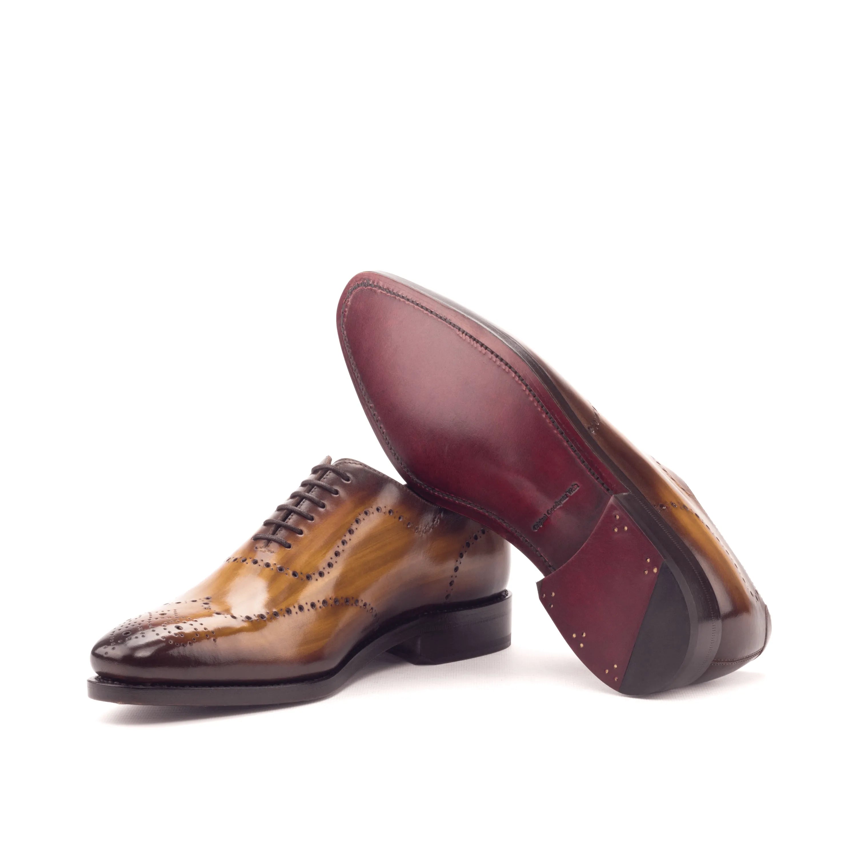 Brown leather wingtip dress shoes, showcasing Roselli Whole Cut Patina design elegance
