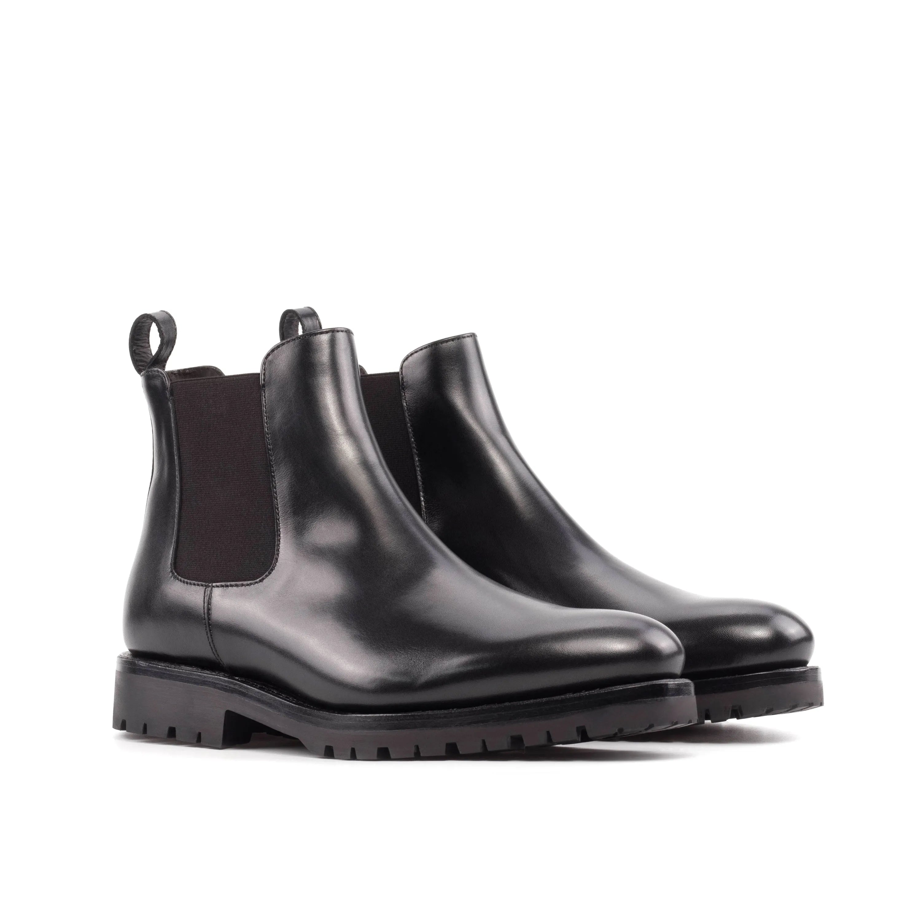 Pair of black leather Solitude Chelsea Boots showcasing elegant and timeless design