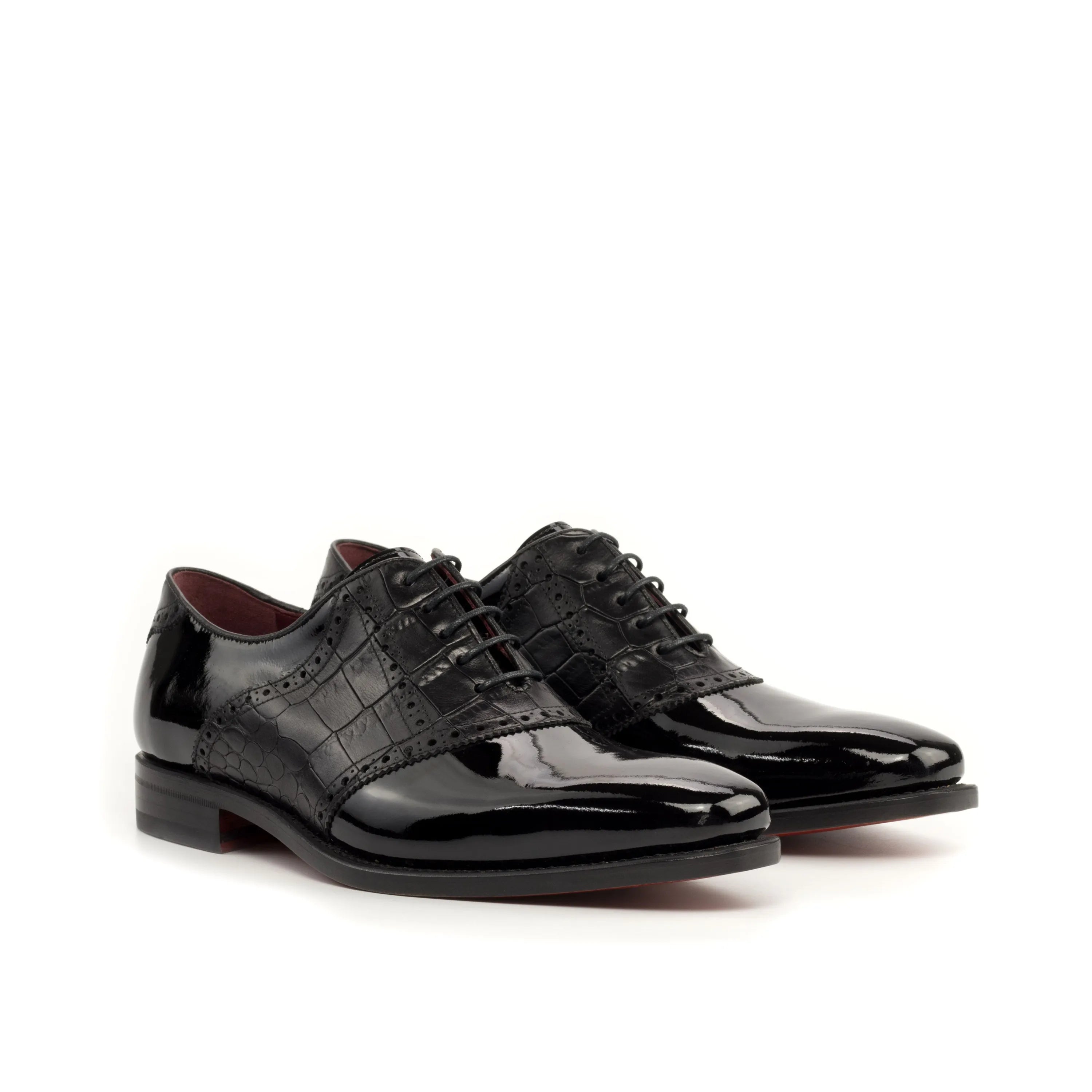 Pair of black patent leather Sorgino Saddle Shoes II in a stylish display