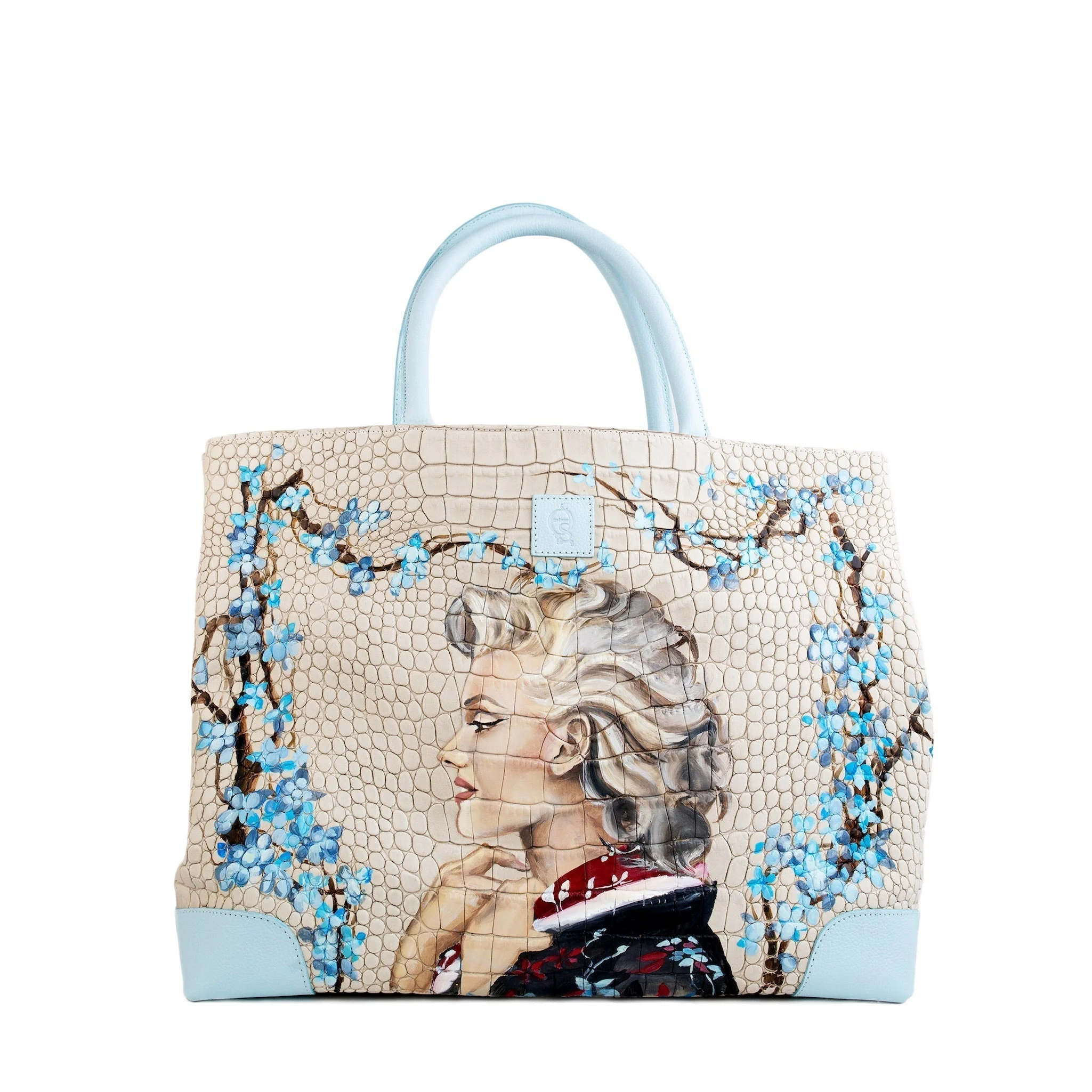 Handbag featuring Marilyn Monroe portrait and floral accents, the Marilyn Weekender Bag in Italian leather