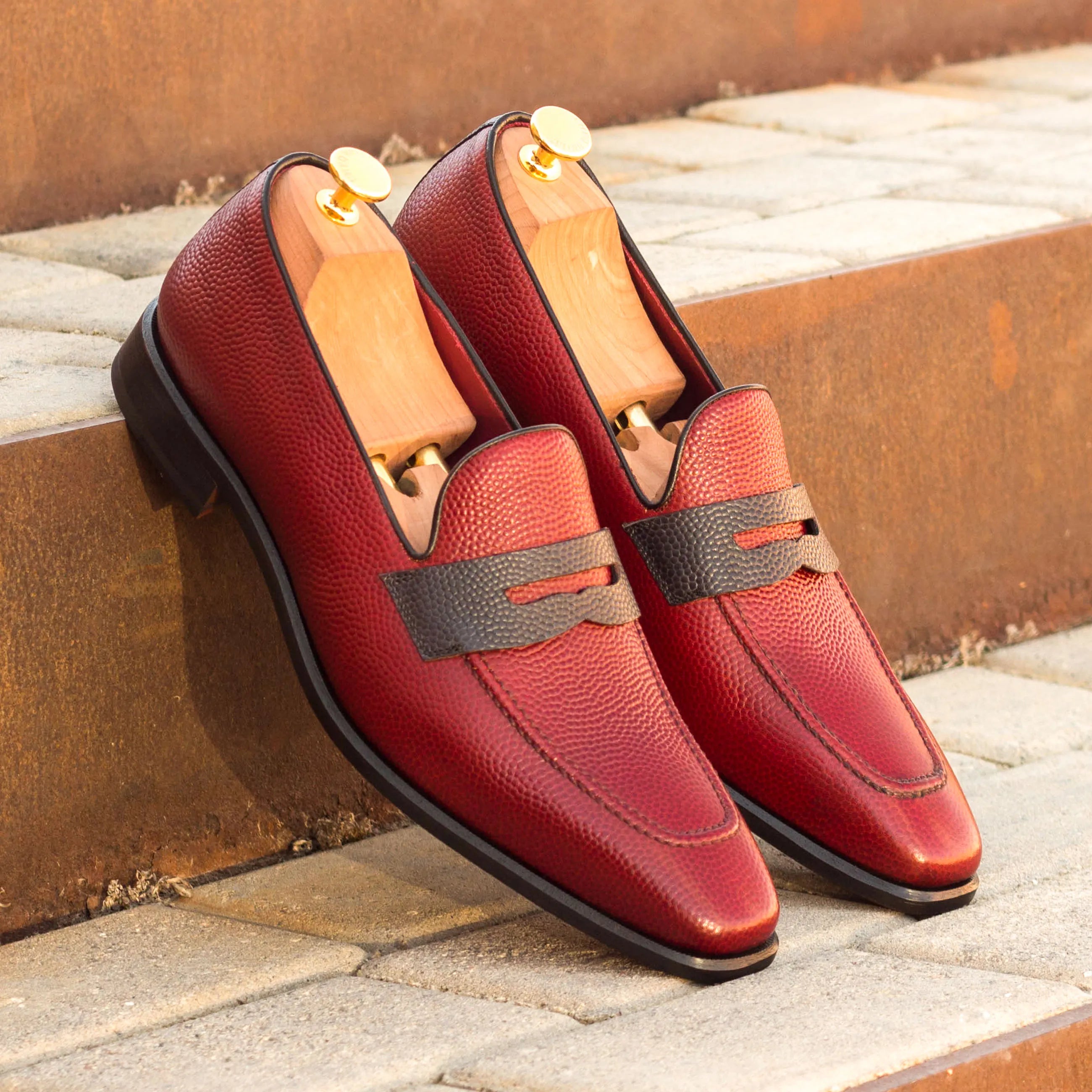 Pair of red leather Tzu Loafers, luxury bespoke shoes for men with pebble grain texture