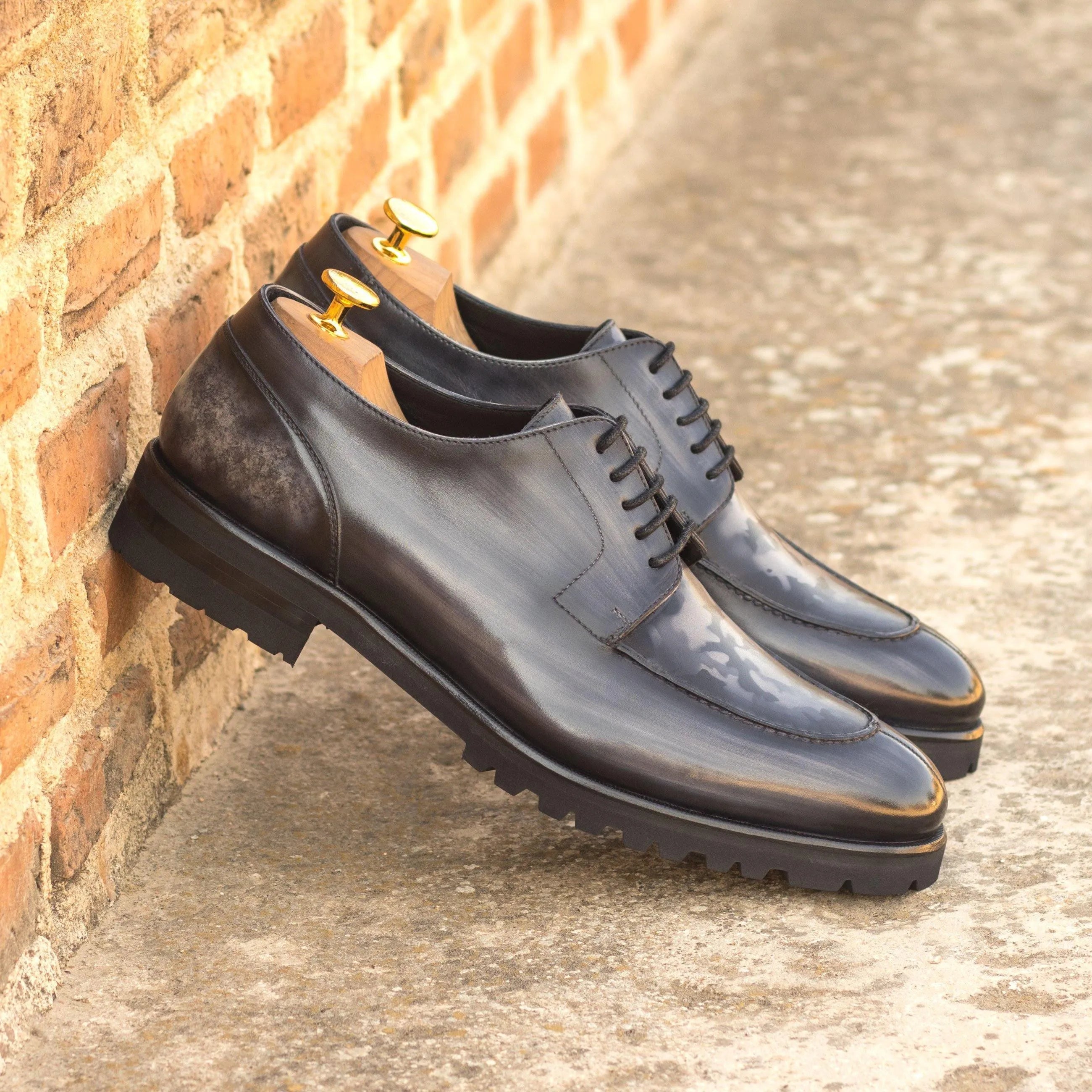Pair of black leather Vega Derby Split Toe Patina shoes II showcasing elegant craftsmanship