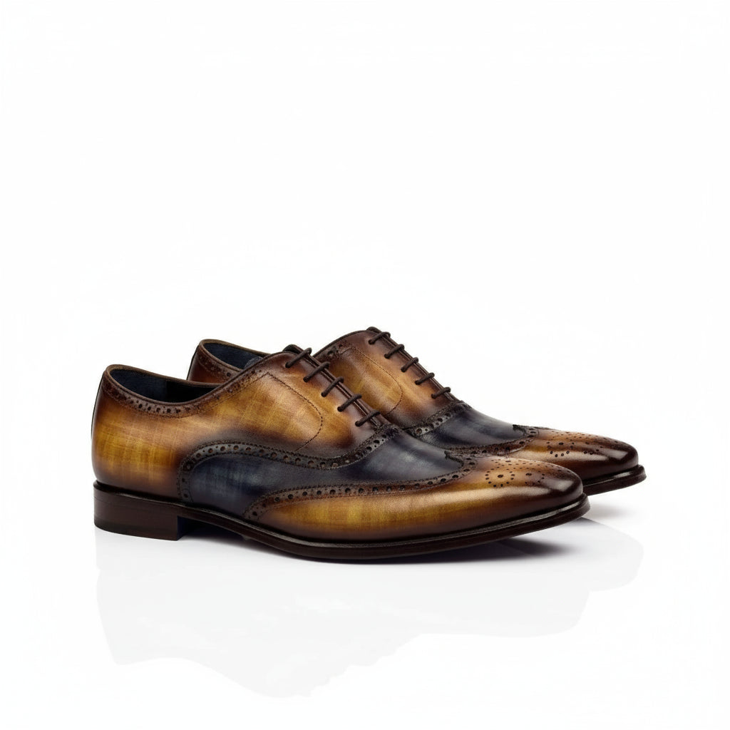 Two-tone leather wingtip dress shoes showcasing the WT Full Brogue Patina design