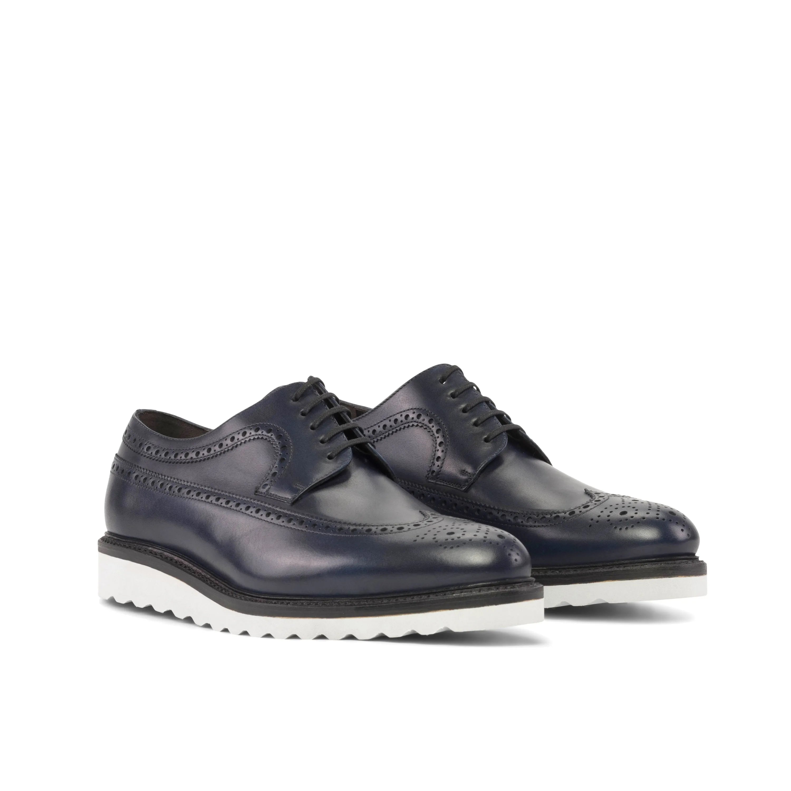 Navy blue leather wingtip blucher shoes with white soles for stylish formal wear