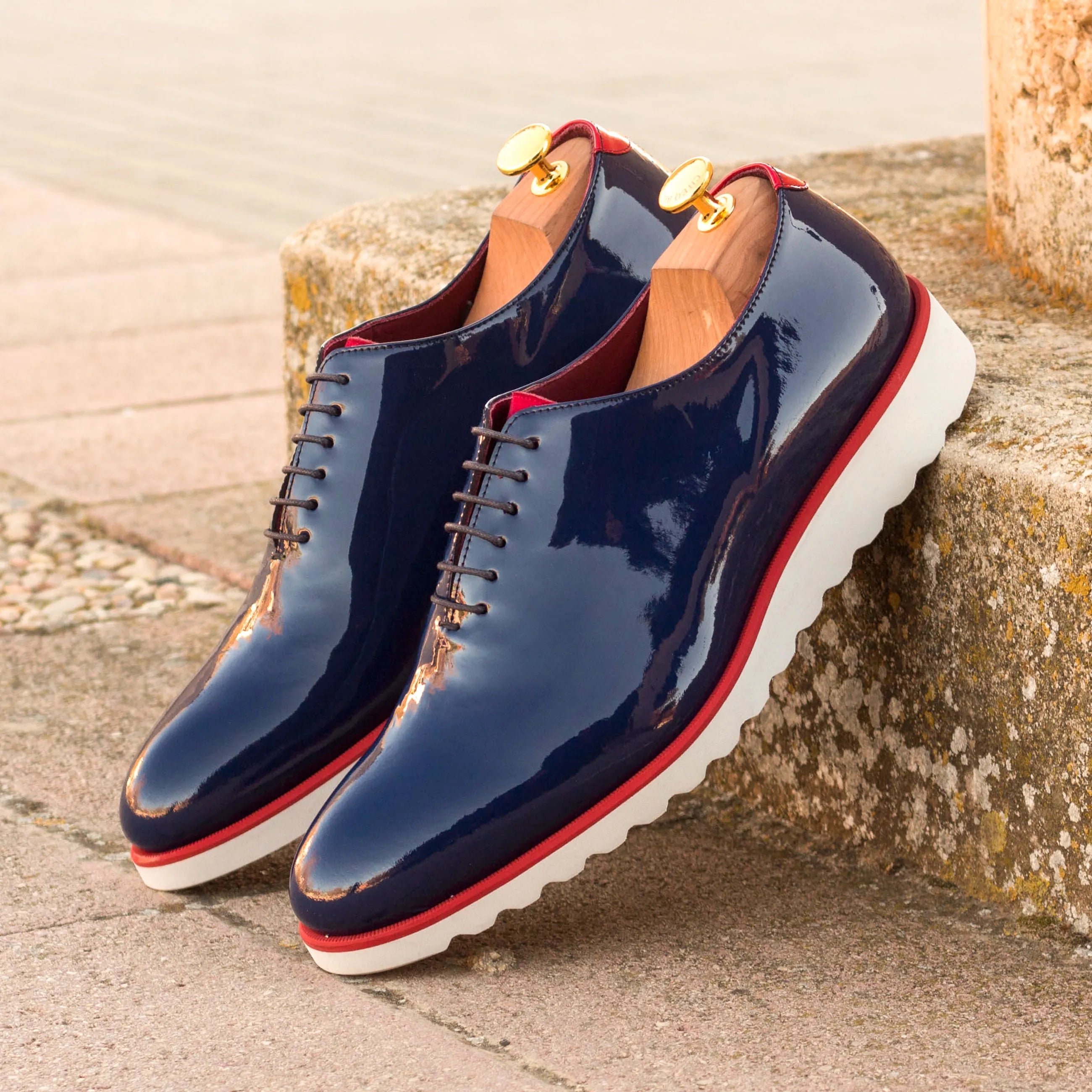 Shiny navy blue Zaid Wholecut shoes showcasing elegant craftsmanship and style
