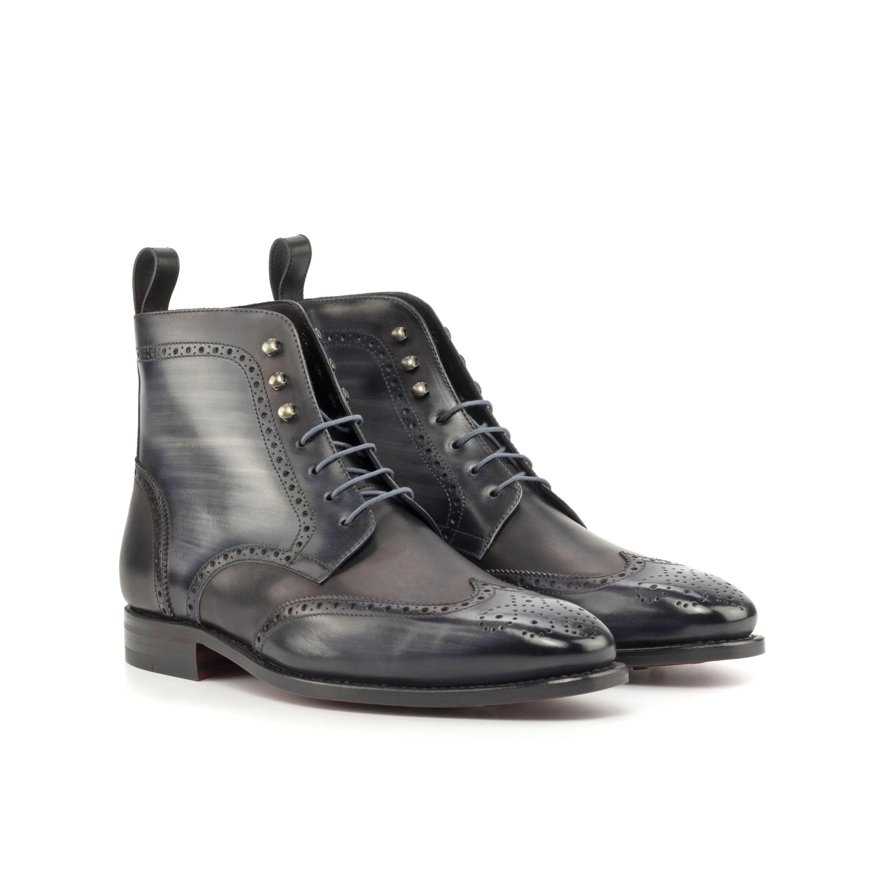 Pair of gray leather Zdan Military Brogue Patina Boots with intricate wingtip design